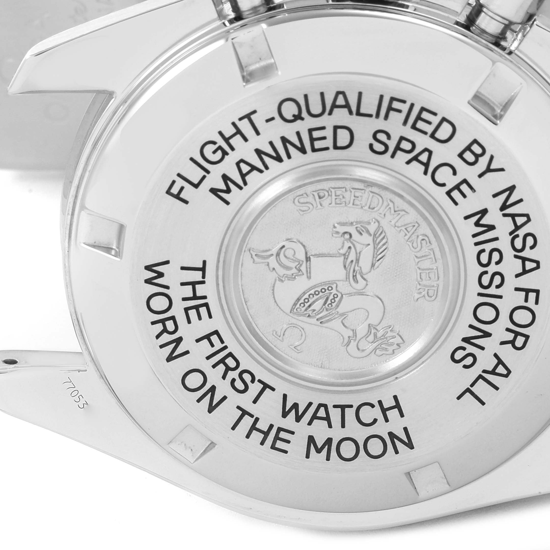 The image shows the case back of an Omega Speedmaster 3575.20.00 Men's Stainless Steel White Dial 3575.20.00 Men's Stainless Steel White Dial watch with engraved text and emblem.