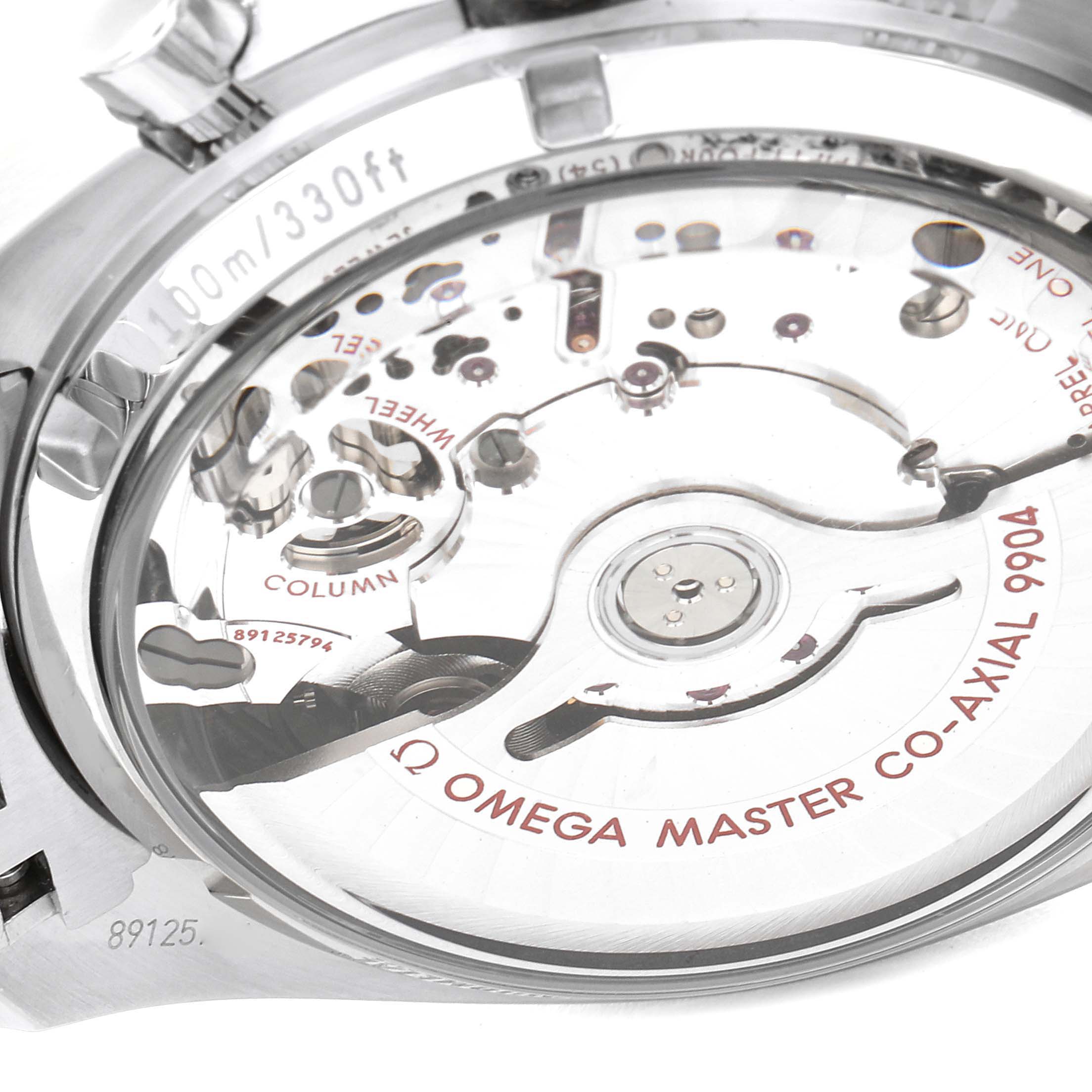 The image shows the back view of the Omega Speedmaster 304.30.44.52.01.001 Men's Stainless Steel Black Dial 304.30.44.52.01.001 Men's Stainless Steel Black Dial watch, highlighting its Co-Axial 9904 movement.