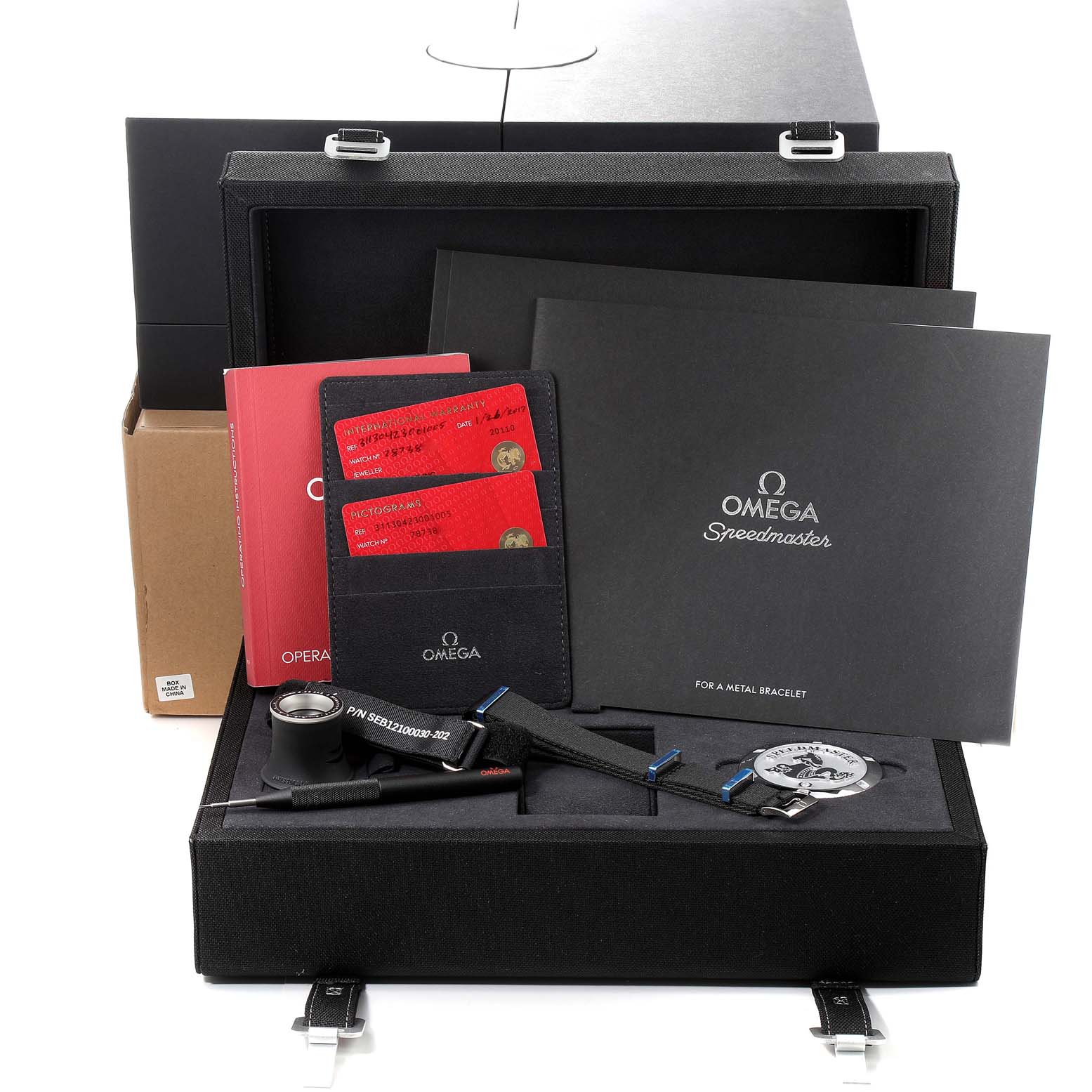 The image shows the packaging, manuals, and accessories of the Omega Speedmaster 311.30.42.30.01.005 Men's Stainless Steel Black Dial 311.30.42.30.01.005 Men's Stainless Steel Black Dial watch, presented at a front-facing angle.