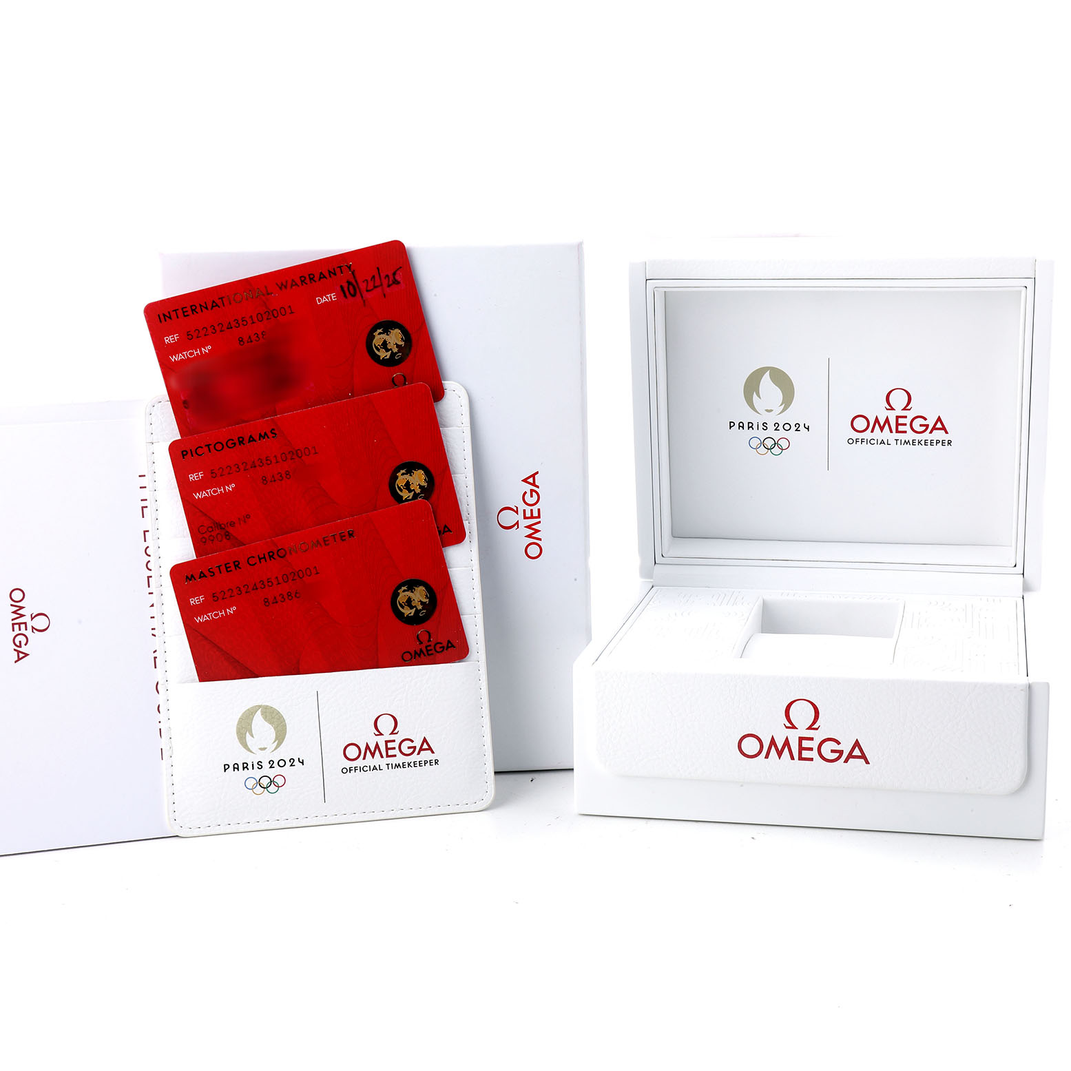 The image shows a white Omega box, cardholder, and warranty cards for the Omega Speedmaster 522.32.43.51.02.001 Men's Stainless Steel Silver Dial.