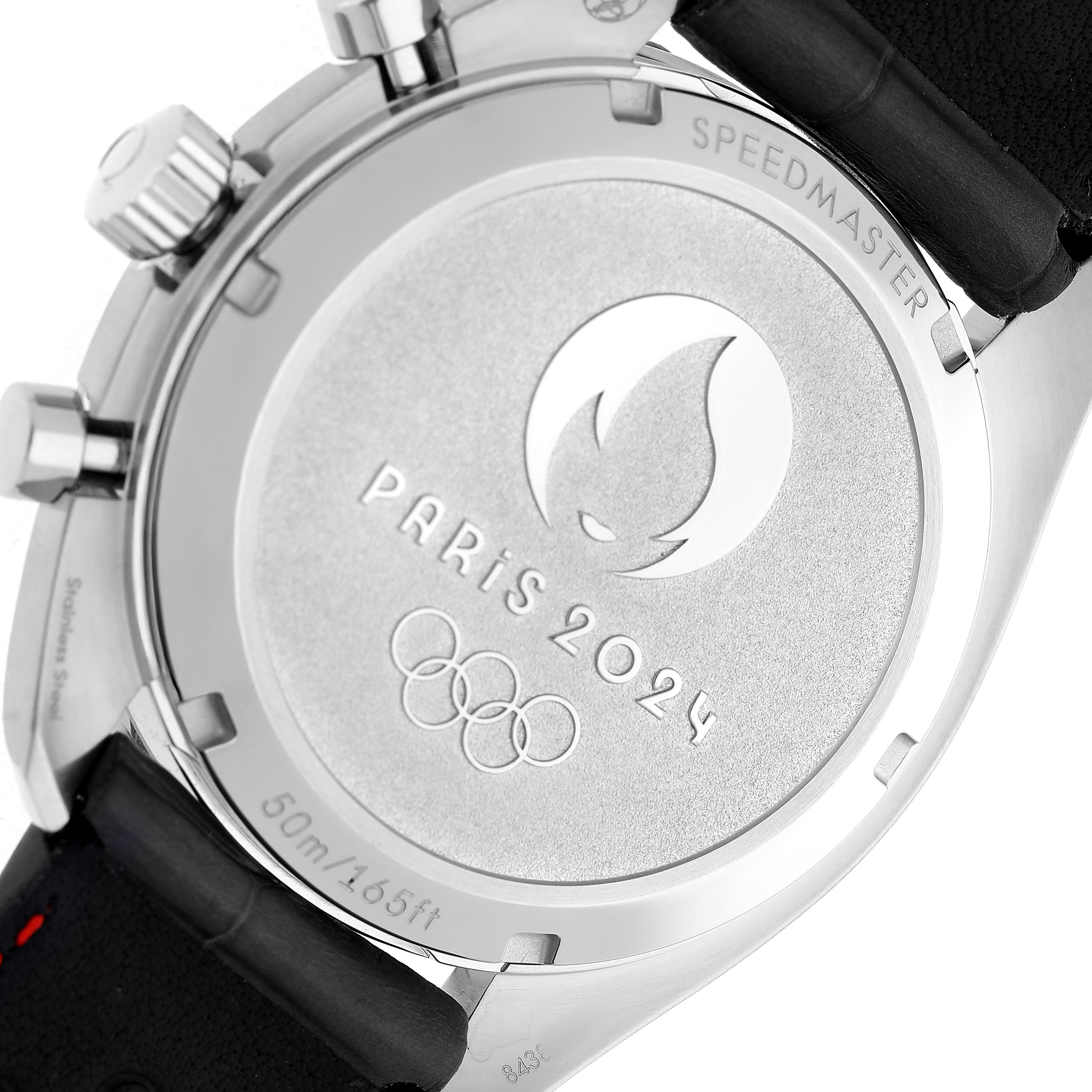 The image shows the back of the Omega Speedmaster 522.32.43.51.02.001 Men's Stainless Steel Silver Dial, featuring "Paris 2024" and Olympic symbols.