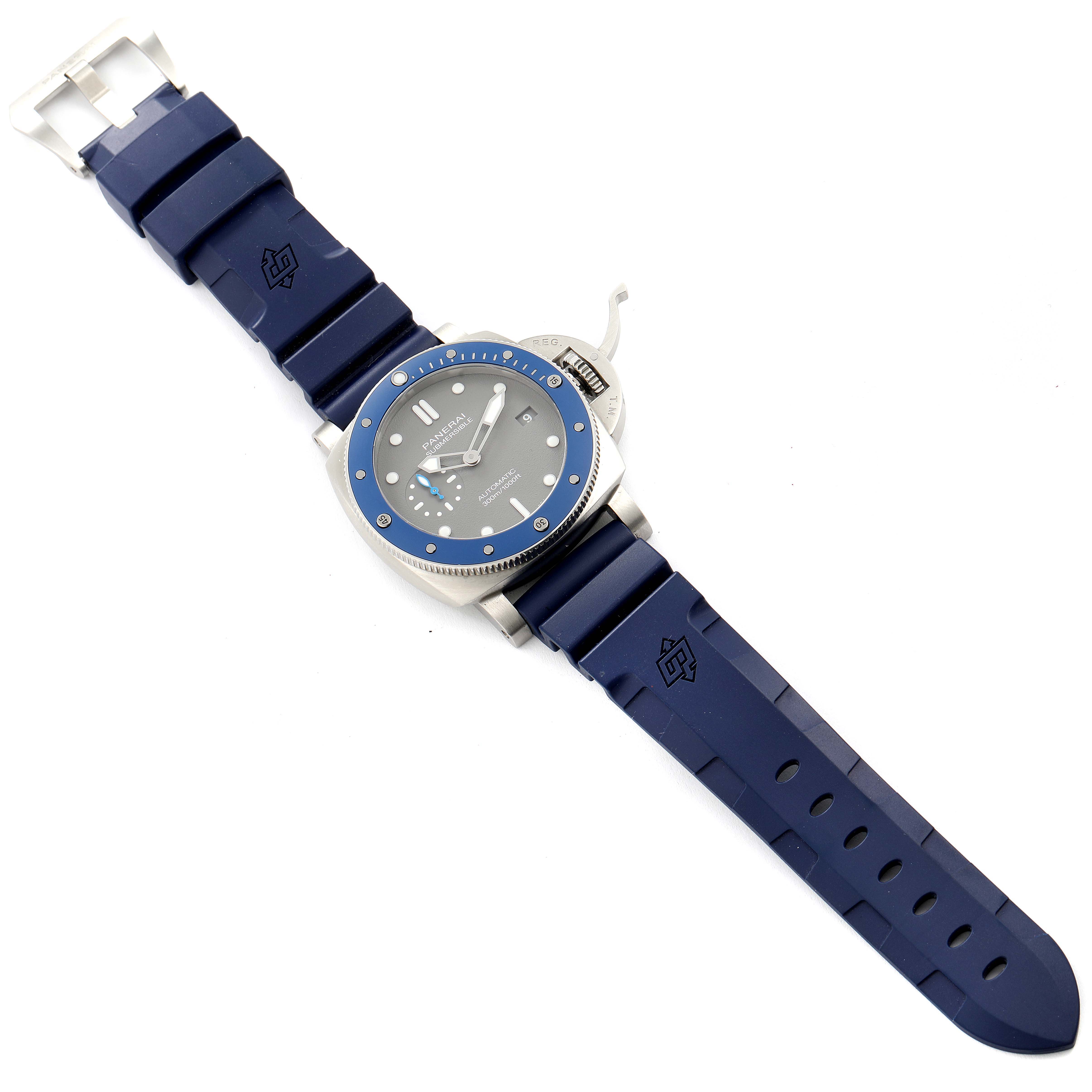 The image shows a Panerai Submersible PAM00959 Men's Stainless Steel Grey Dial PAM00959 Men's Stainless Steel Grey Dial watch from a top-down angle, displaying its blue strap, case, bezel, and dial.