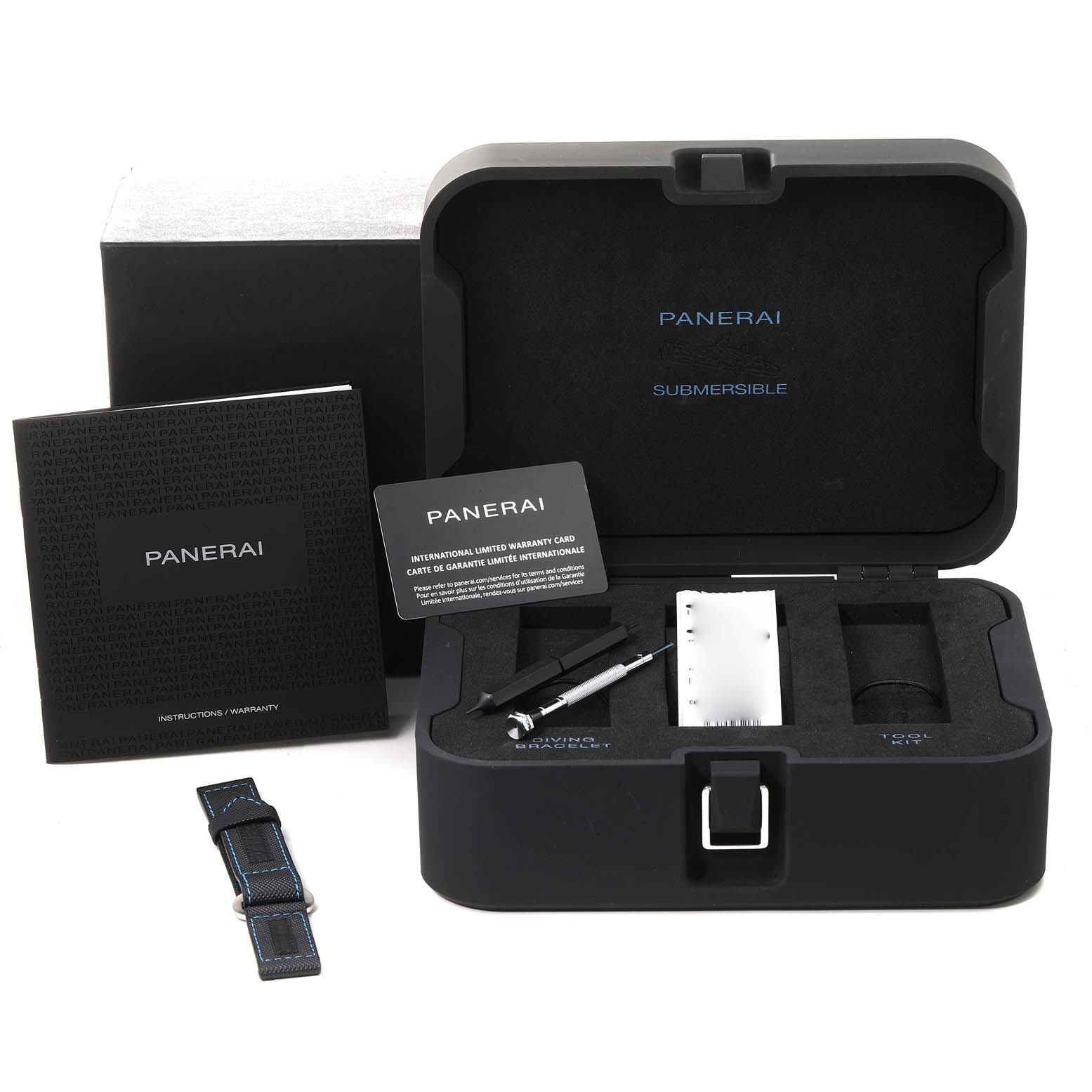 This image shows an open Panerai Submersible PAM00959 Men's Stainless Steel Grey Dial PAM00959 Men's Stainless Steel Grey Dial watch case with the warranty card, instructions, additional strap, and tools.