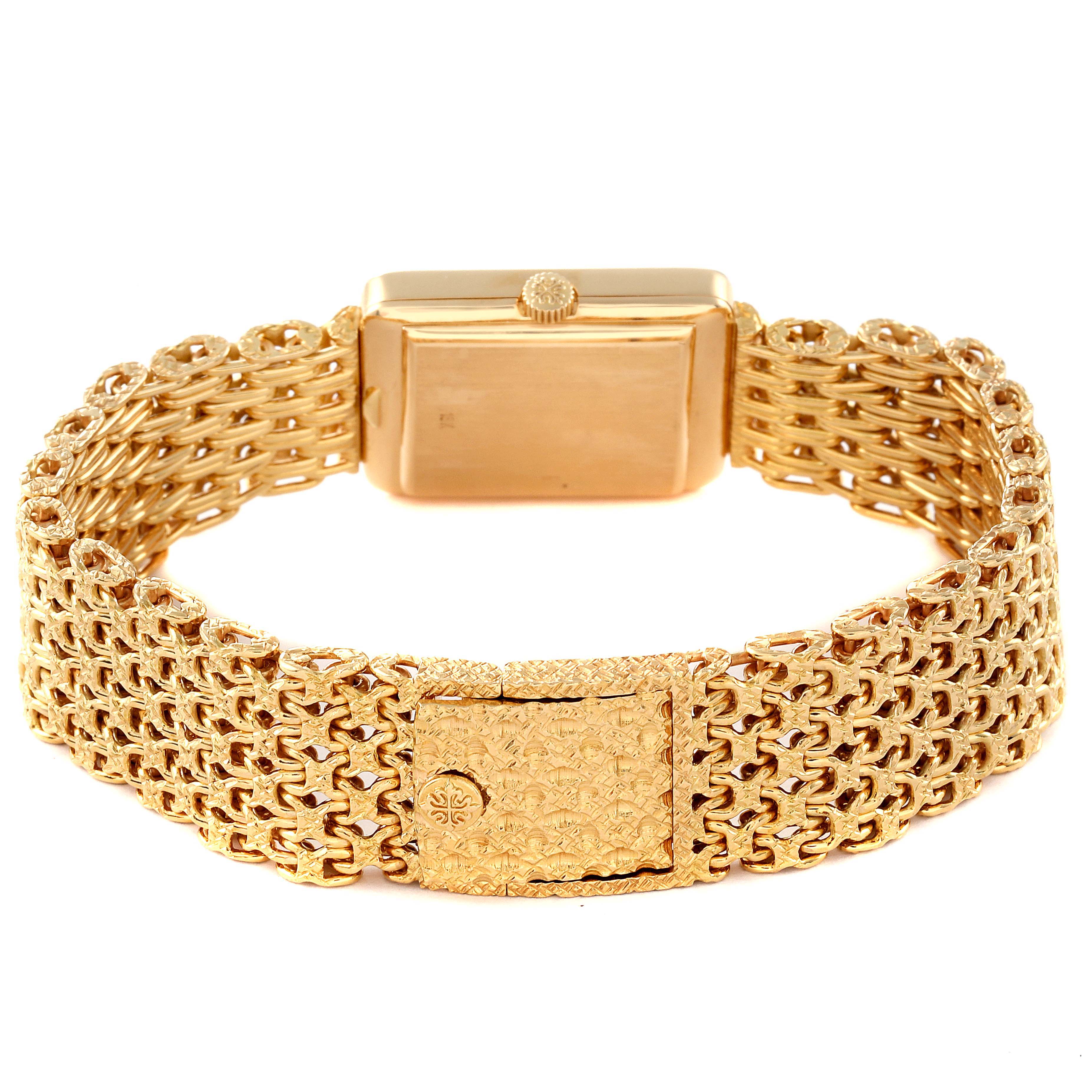 This image shows the back view of a Patek Philippe Gondolo 4224 - 1 Women's Yellow Gold Brown Dial 4224 - 1 Women's Yellow Gold Brown Dial watch, highlighting its intricate gold bracelet and clasp.