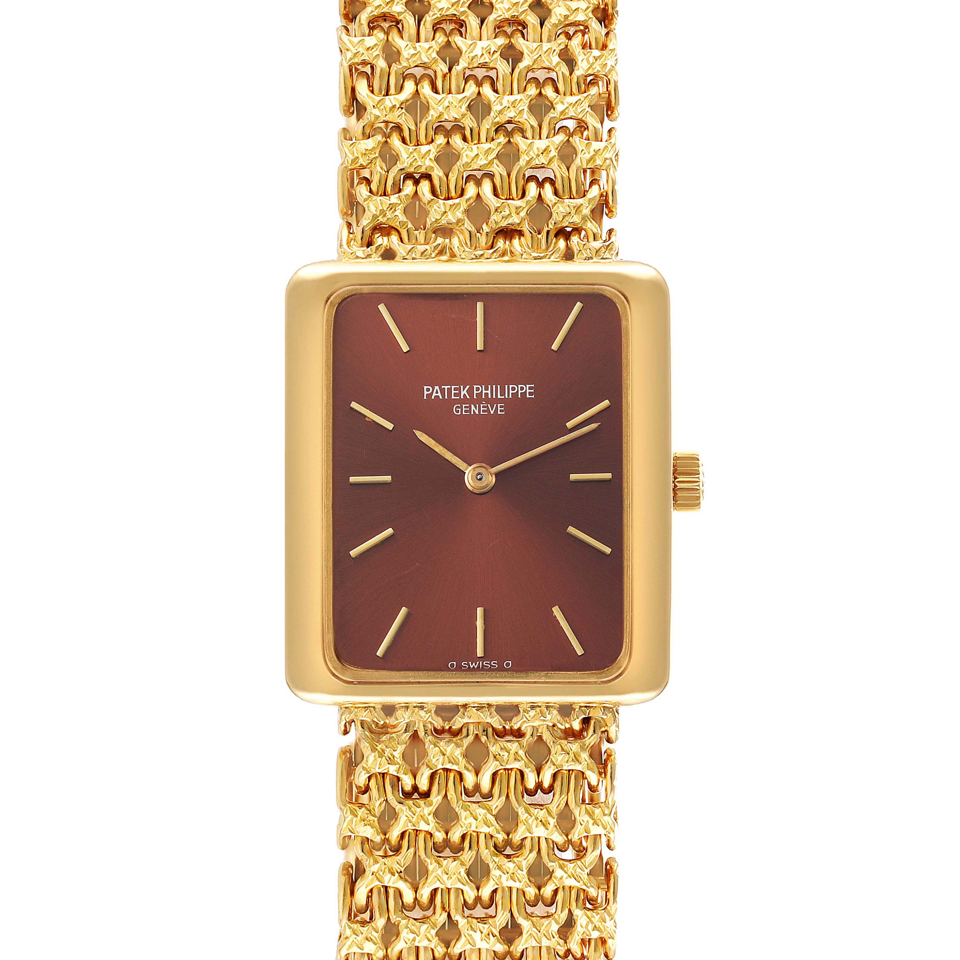 The Patek Philippe Gondolo 4224 - 1 Women's Yellow Gold Brown Dial 4224 - 1 Women's Yellow Gold Brown Dial watch is shown from a front angle, highlighting its rectangular dial and intricate gold bracelet.