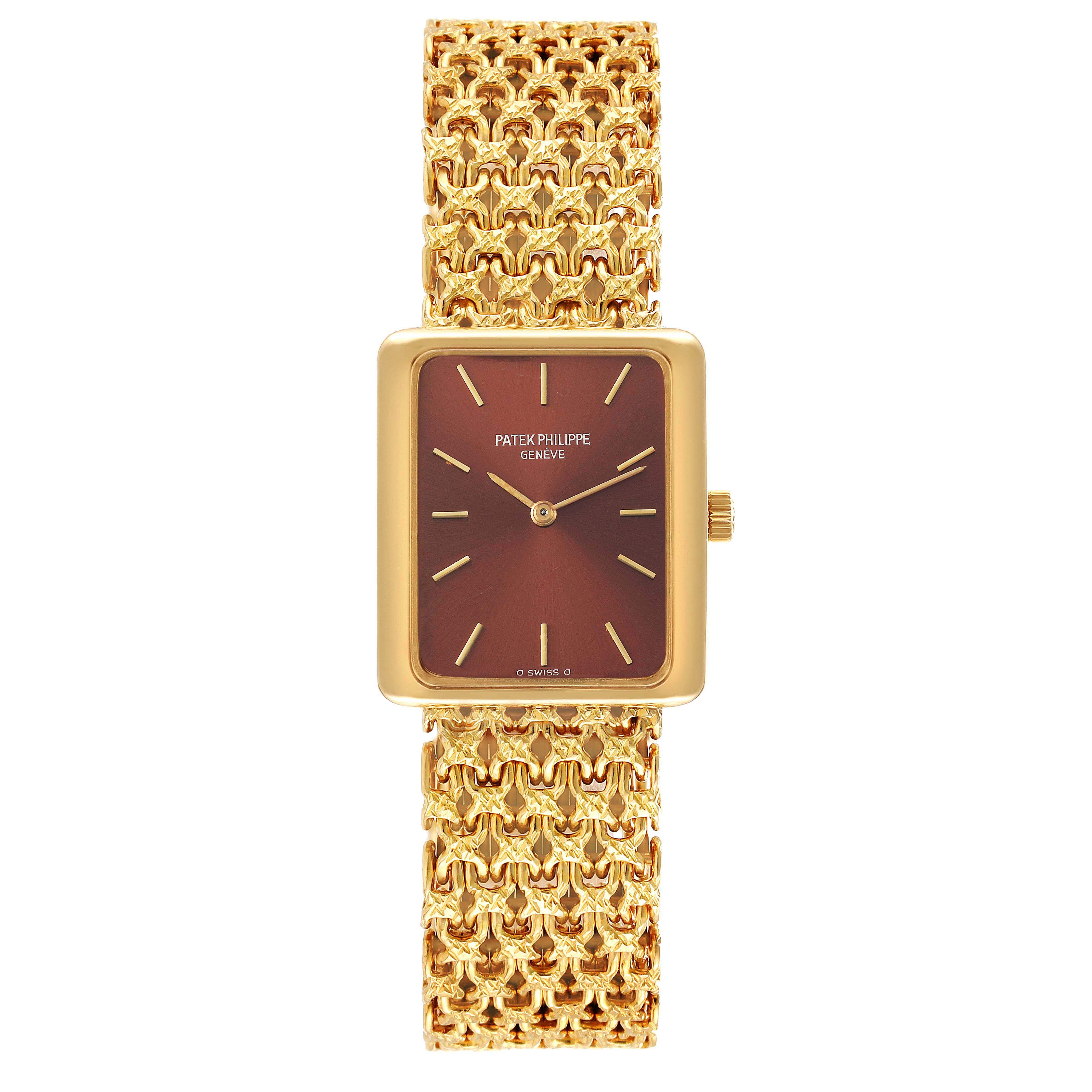 The Patek Philippe Gondolo 4224 - 1 Women's Yellow Gold Brown Dial 4224 - 1 Women's Yellow Gold Brown Dial watch is shown from a top-down angle, highlighting its gold rectangular case and intricate gold bracelet.
