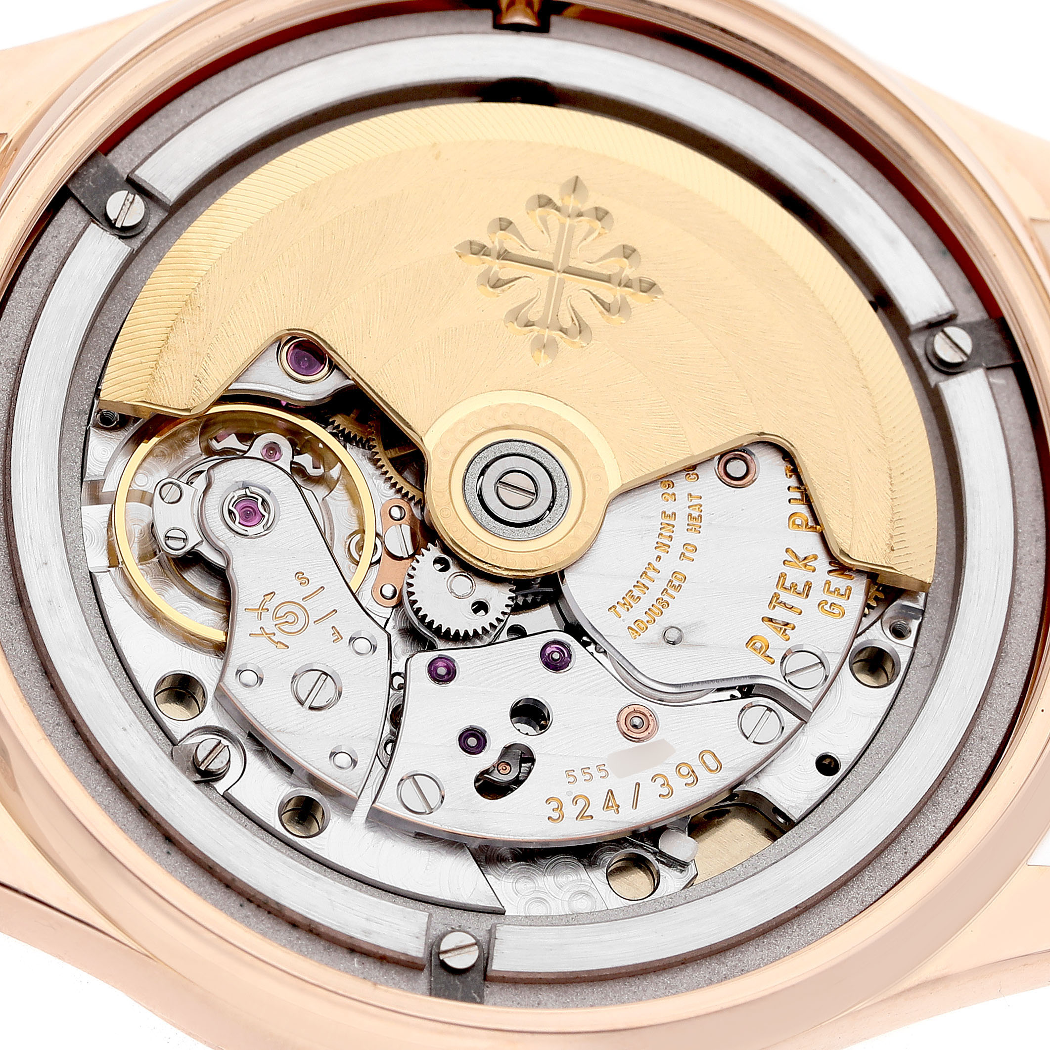 The image shows a close-up of the movement mechanism of a Patek Philippe Calatrava 5296R-010 Men's Rose Gold Silver Dial watch, highlighting gears and the rotor.