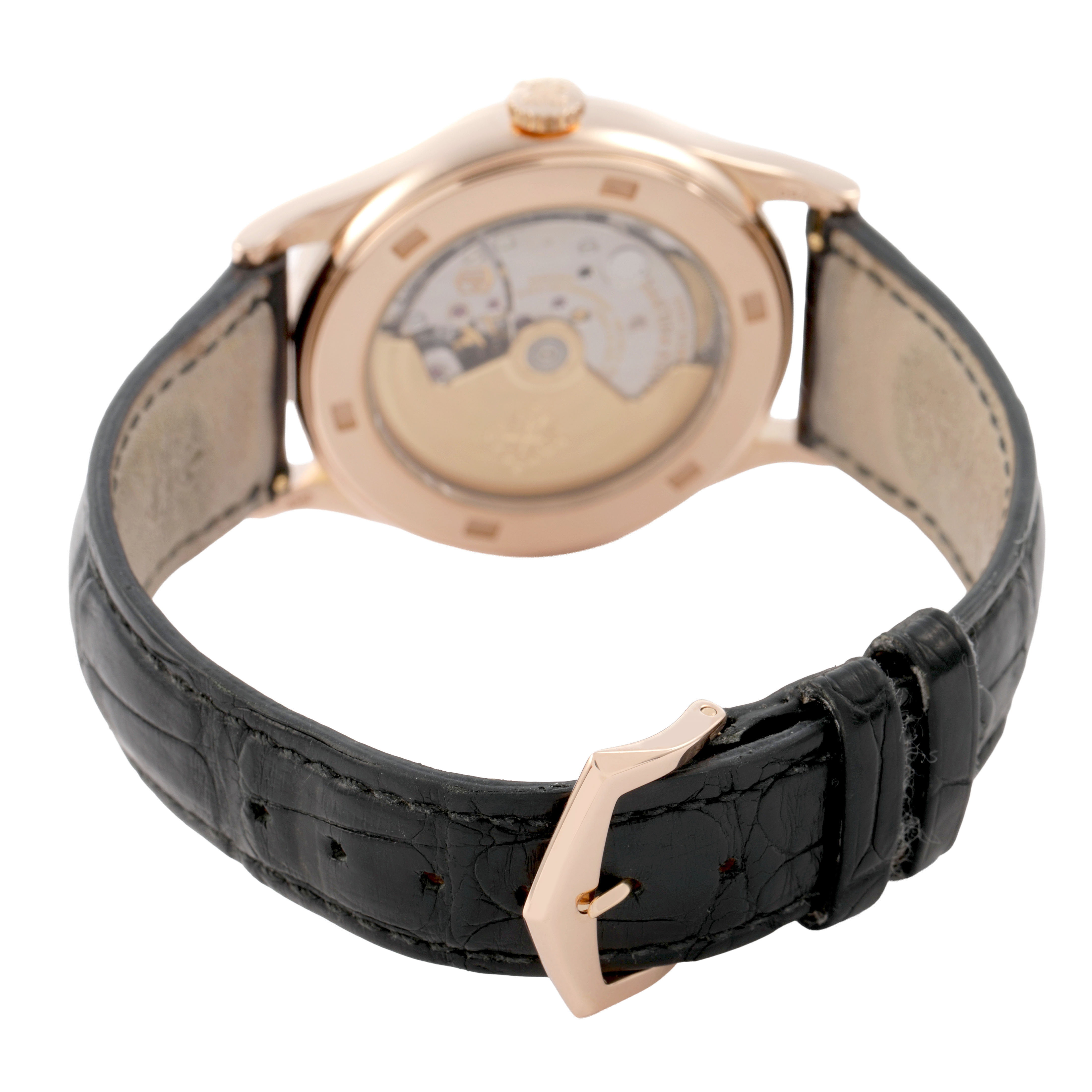 The image shows the back of a Patek Philippe Calatrava 5296R-010 Men's Rose Gold Silver Dial watch, highlighting its movement and leather strap with buckle.