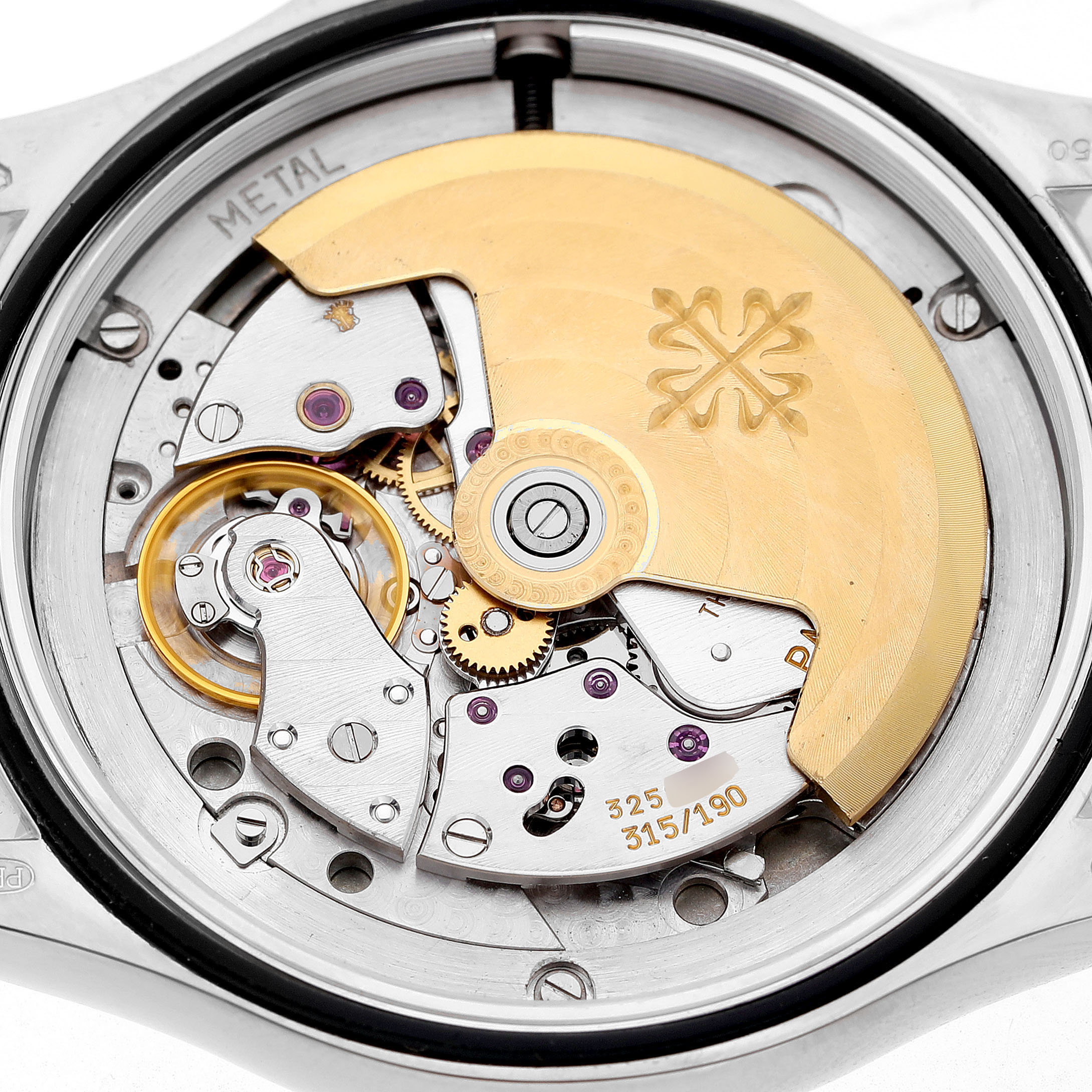 The image shows the intricate movement of a Patek Philippe Calatrava 5107G Men's White Gold Silver Dial watch from a top-down angle.