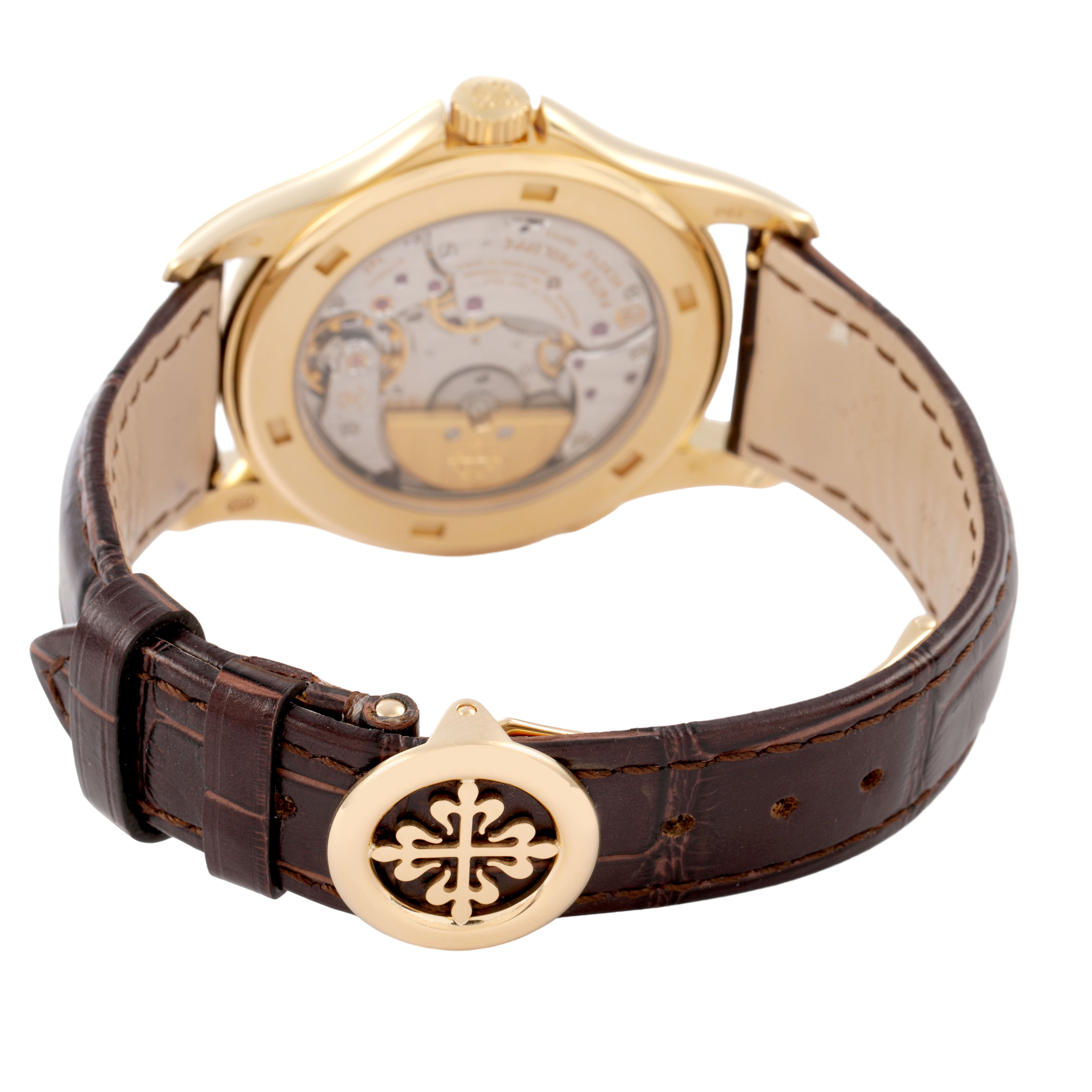 The Patek Philippe Complications 5130J Men's Yellow Gold Silver Dial watch is shown from the back, highlighting the movement and leather strap with a decorative clasp.
