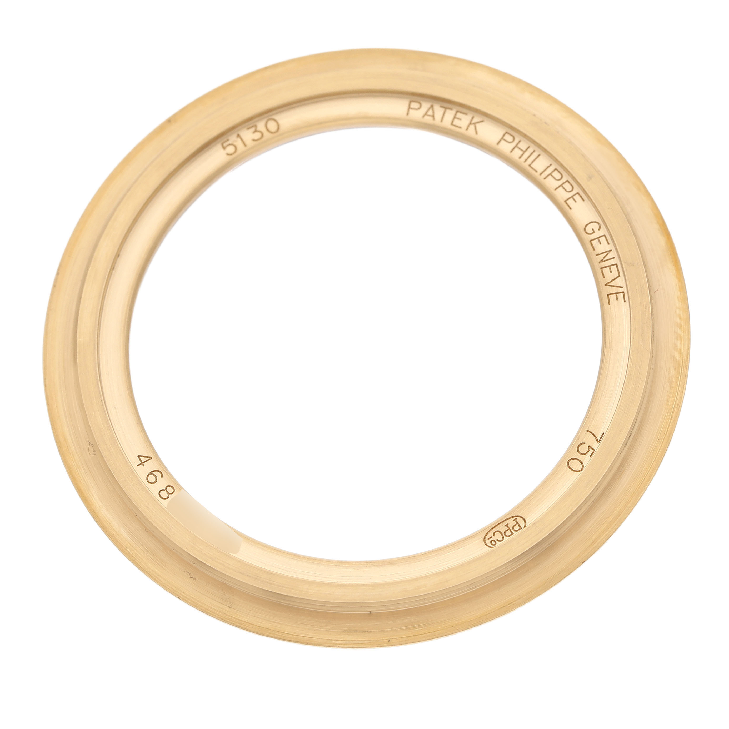 The image shows a Patek Philippe Complications 5130J Men's Yellow Gold Silver Dial model bezel, viewed from above, engraved with brand and model details.