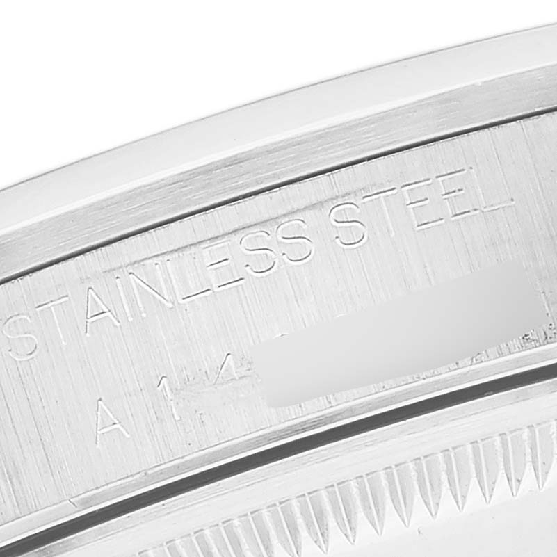 The image shows a close-up of the back case rim of a Rolex Date 15200 Men's Stainless Steel Black Dial 15200 Men's Stainless Steel Black Dial model, highlighting the "STAINLESS STEEL" engraving.