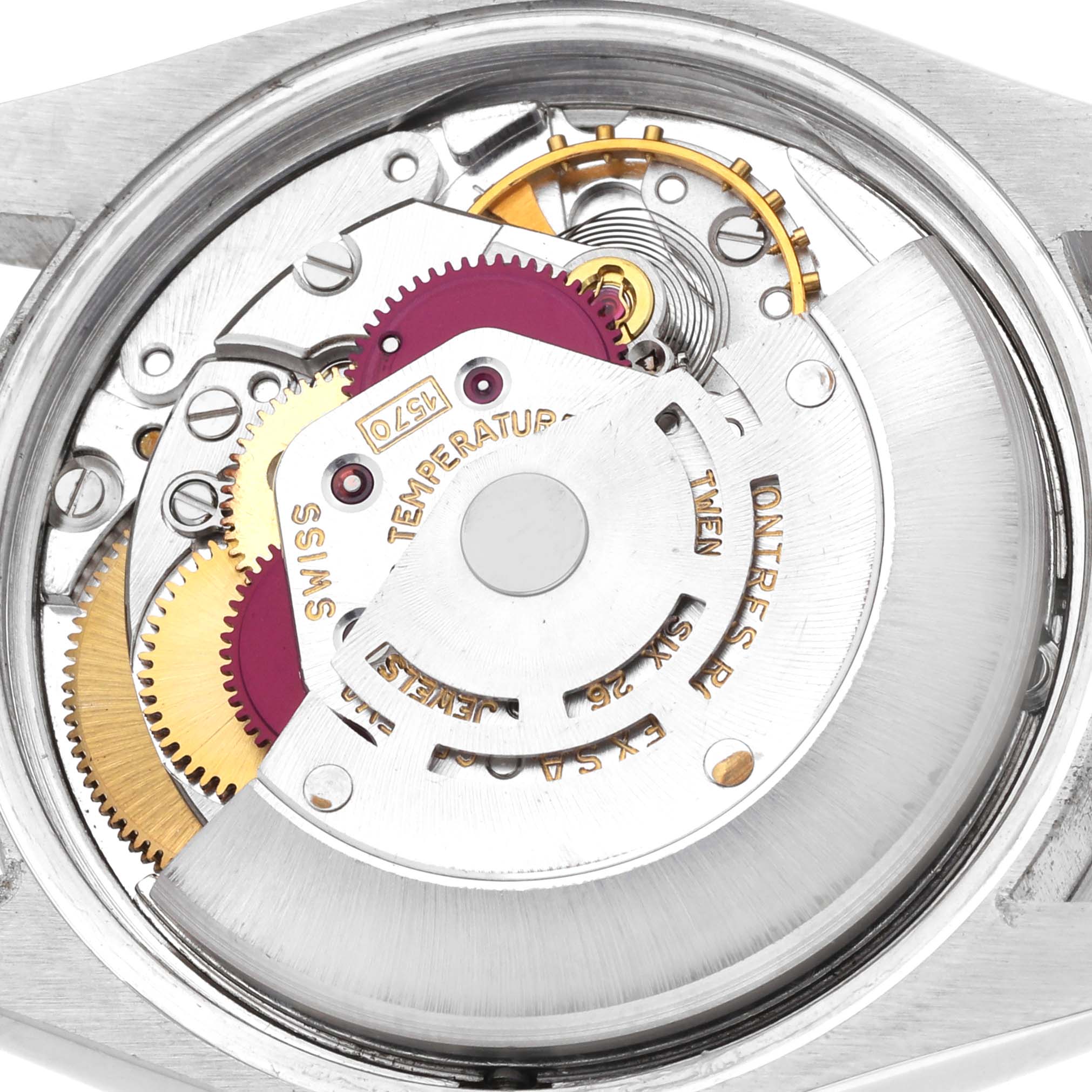 The image shows a close-up of the movement and gears inside a Rolex Date watch.