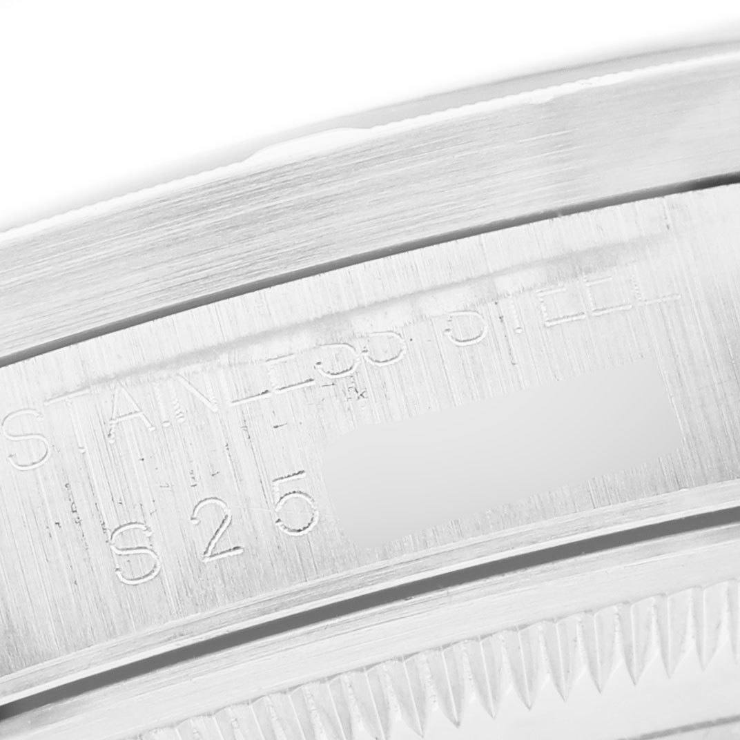 The image shows a close-up of the brushed stainless steel case side of the Rolex Date 15210 Men's Stainless Steel Blue Dial watch.