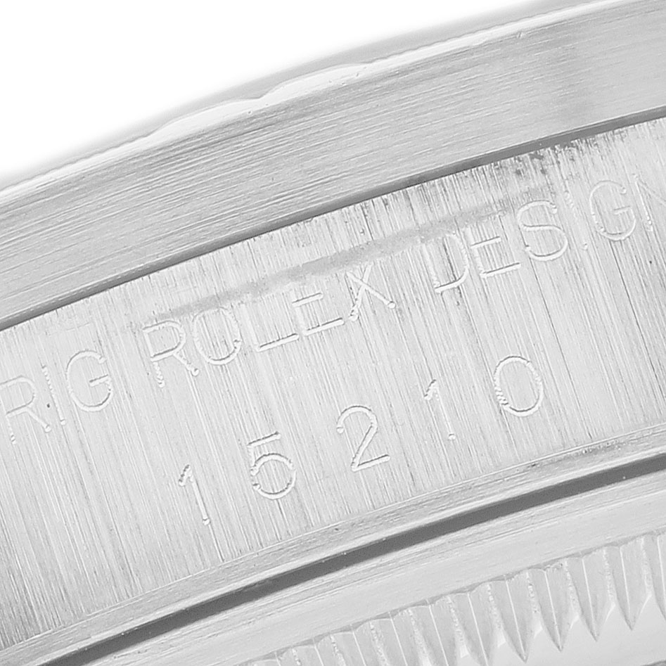 The image shows a close-up of the side engraving on the bezel of a Rolex Date 15210 Men's Stainless Steel Blue Dial watch.