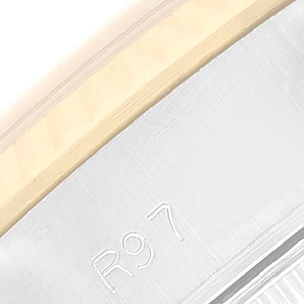 The image shows a close-up angle of the edge of a Rolex Date 69173 Women's Steel and Gold (two tone) Silver Dial 69173 Women's Steel and Gold (two tone) Silver Dial model watch, highlighting the engraved serial number.