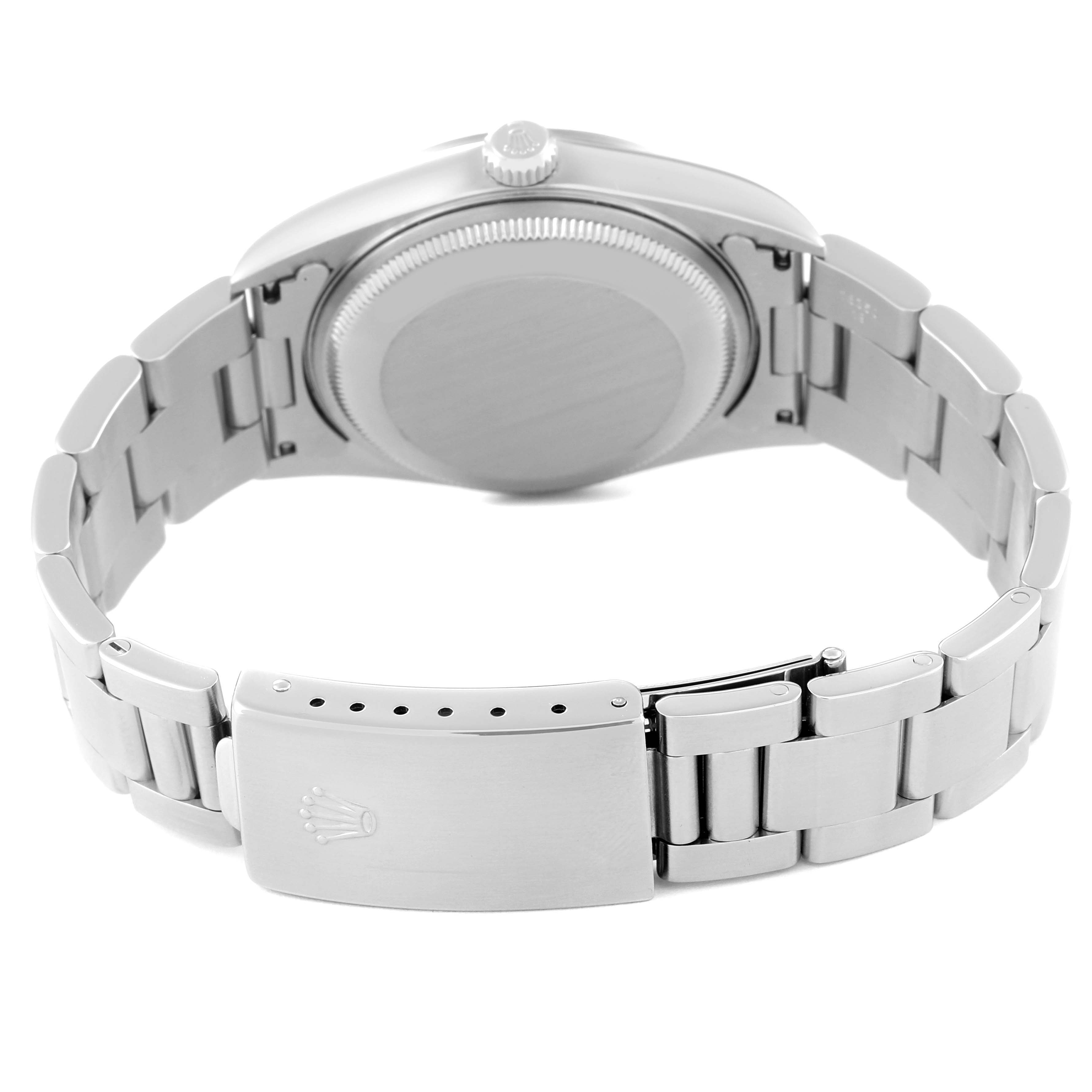 The image shows the backside and clasp of a Date model Rolex watch from a rear angle.