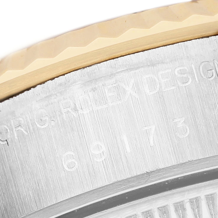 The close-up image shows the engraved case side of a Rolex Datejust 69173 Women's Steel and Gold (two tone) Champagne Dial, focusing on the model number.