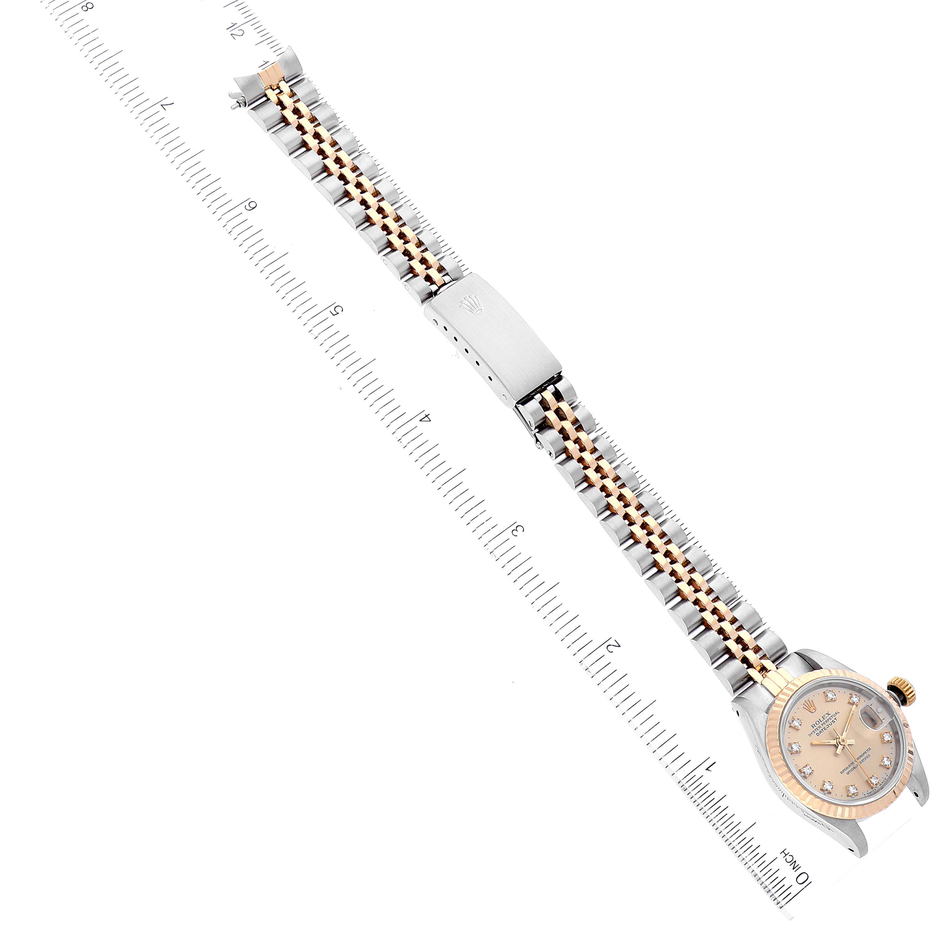 The image shows a Rolex Datejust 69173 Women's Steel and Gold (two tone) Champagne Dial 69173 Women's Steel and Gold (two tone) Champagne Dial model watch laid flat, displaying the face, bracelet, and clasp, next to a ruler for scale.