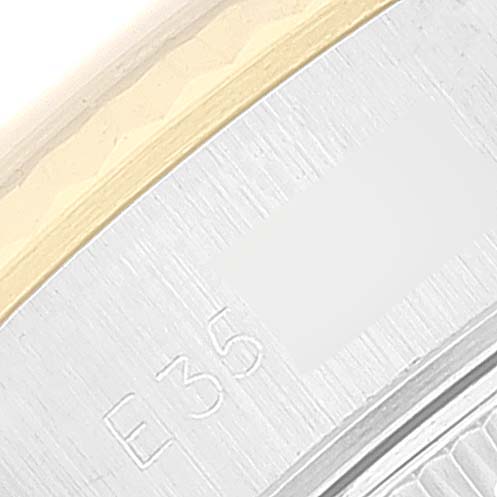 The image shows a close-up of the engraved bezel and part of the case of a Rolex Datejust 69173 Women's Steel and Gold (two tone) Champagne Dial 69173 Women's Steel and Gold (two tone) Champagne Dial watch.