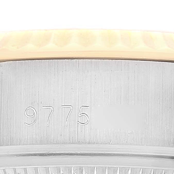 This image shows a close-up of the side of a Rolex Datejust 69173 Women's Steel and Gold (two tone) Champagne Dial 69173 Women's Steel and Gold (two tone) Champagne Dial, featuring part of the bezel and the serial number.
