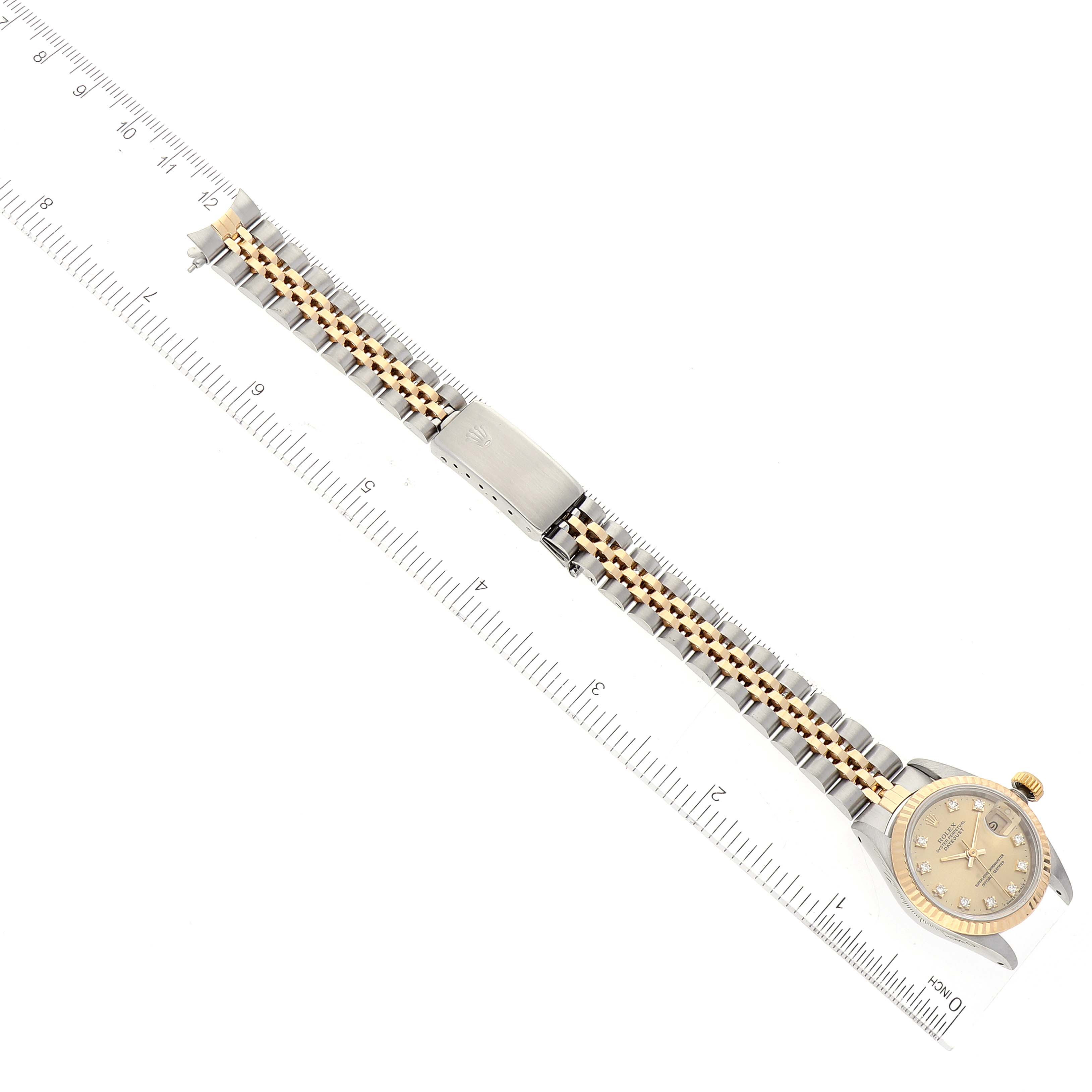 The image shows a Rolex Datejust 69173 Women's Steel and Gold (two tone) Champagne Dial 69173 Women's Steel and Gold (two tone) Champagne Dial watch laid flat with a ruler for scale, displaying the wristband and watch face.