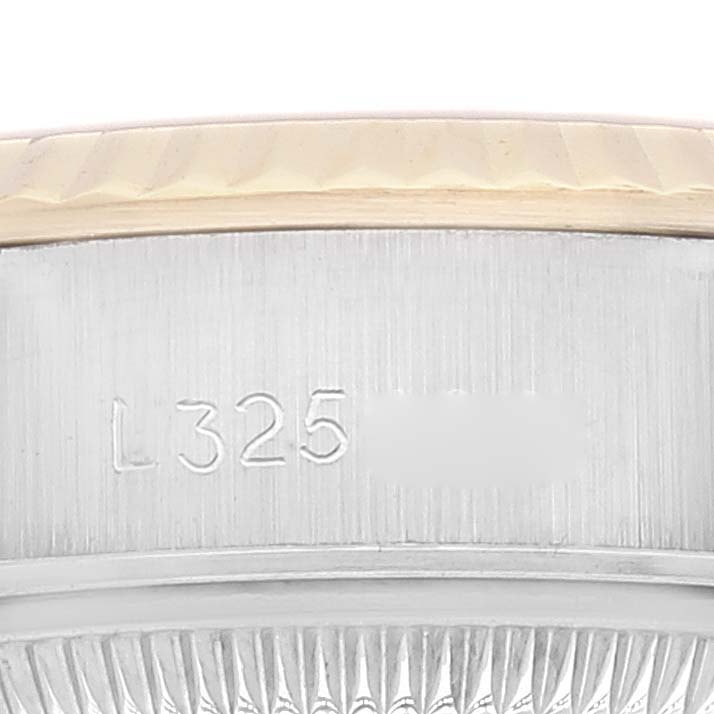 The image shows a close-up angle of the serial number engraving on the side of the Rolex Datejust 69173 Women's Steel and Gold (two tone) White Dial 69173 Women's Steel and Gold (two tone) White Dial watch case.