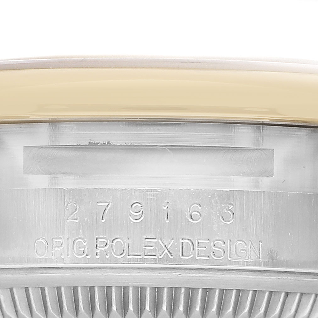 The image focuses on the side of a Rolex Datejust 279163 Women's Steel and Gold (two tone) Silver Dial watch showing the serial number and "ORIG ROLEX DESIGN" engraving.