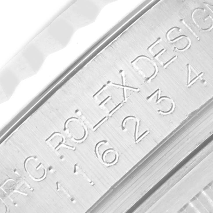 This image shows a close-up of a Rolex Datejust 116234 Men's Stainless Steel Mother of Pearl Dial watch's edge, featuring engraved serial and design numbers.