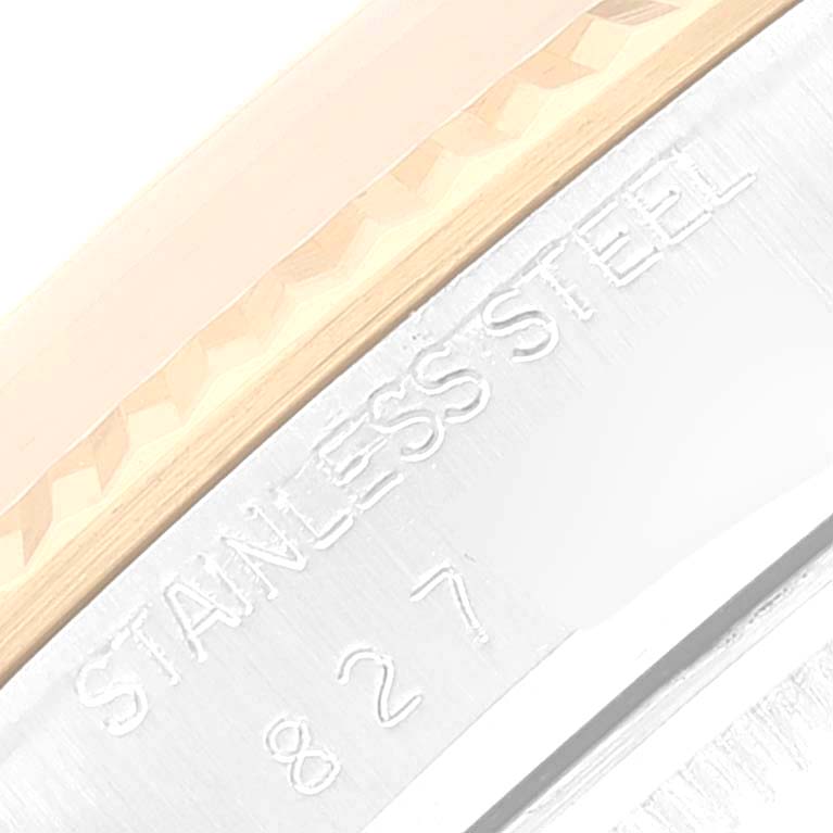 The image shows a close-up angle of the Rolex Vintage Collection 16013 Men's Steel and Gold (two tone) Champagne Dial 16013 Men's Steel and Gold (two tone) Champagne Dial watch, focusing on its bezel and stainless steel marking.