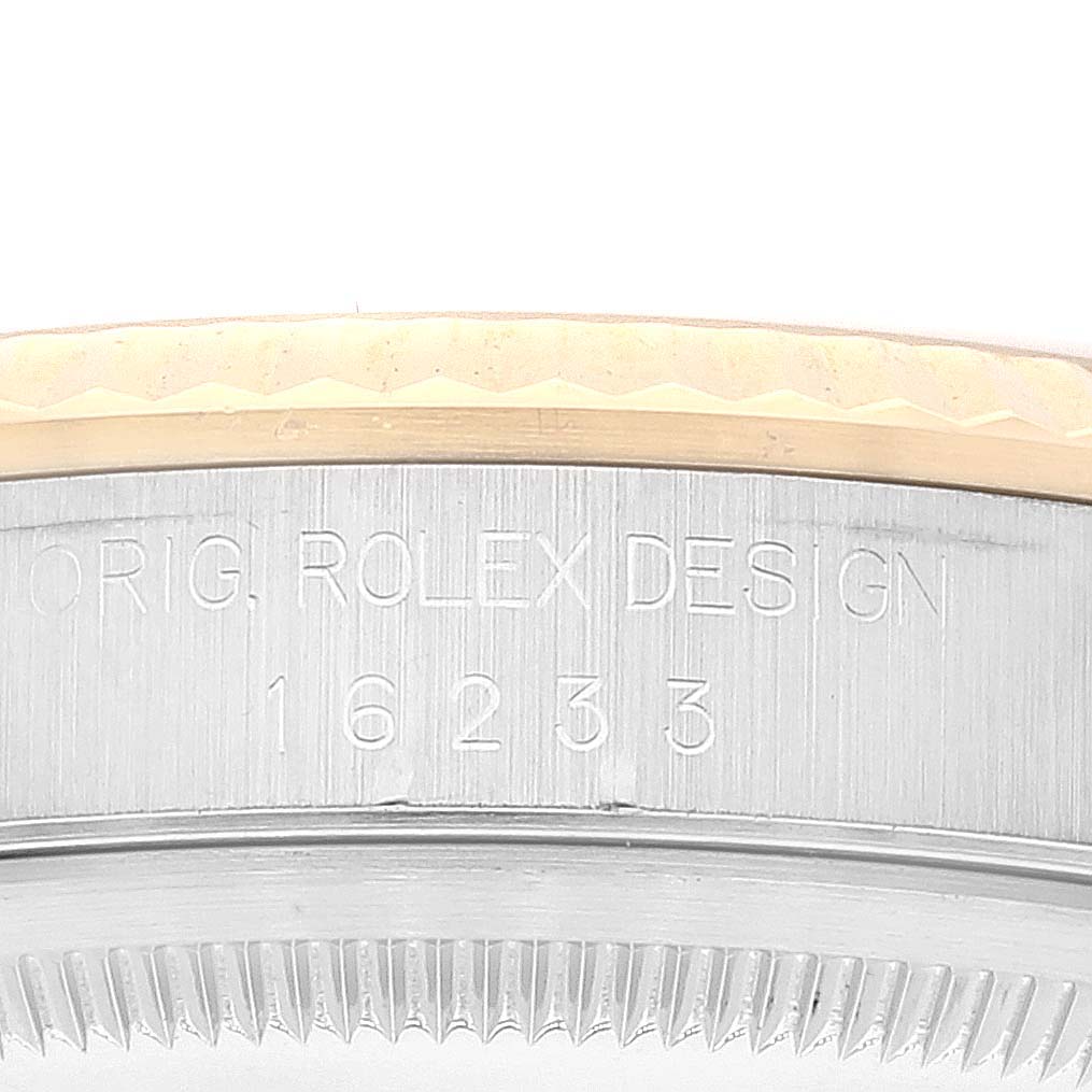 This image shows a close-up of the side of a Rolex Datejust 16233 Men's Steel and Gold (two tone) Champagne Dial 16233 Men's Steel and Gold (two tone) Champagne Dial watch, highlighting the serial number and "ROLEX DESIGN" engraving.