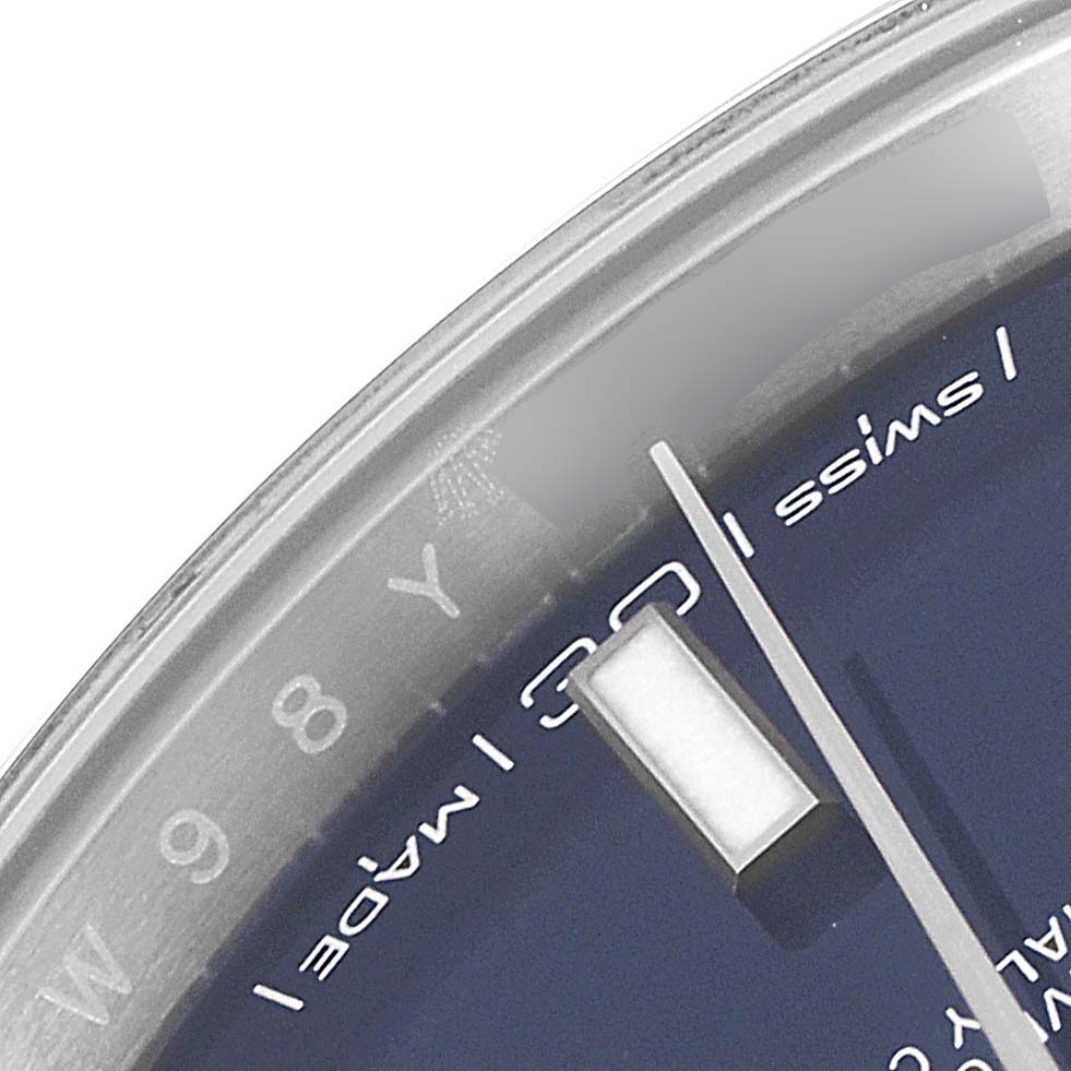 This close-up angle of the Rolex Datejust 41 126300 Men's Stainless Steel Blue Dial 126300 Men's Stainless Steel Blue Dial watch shows segments of the dial, hand, and the edge of the sapphire crystal.