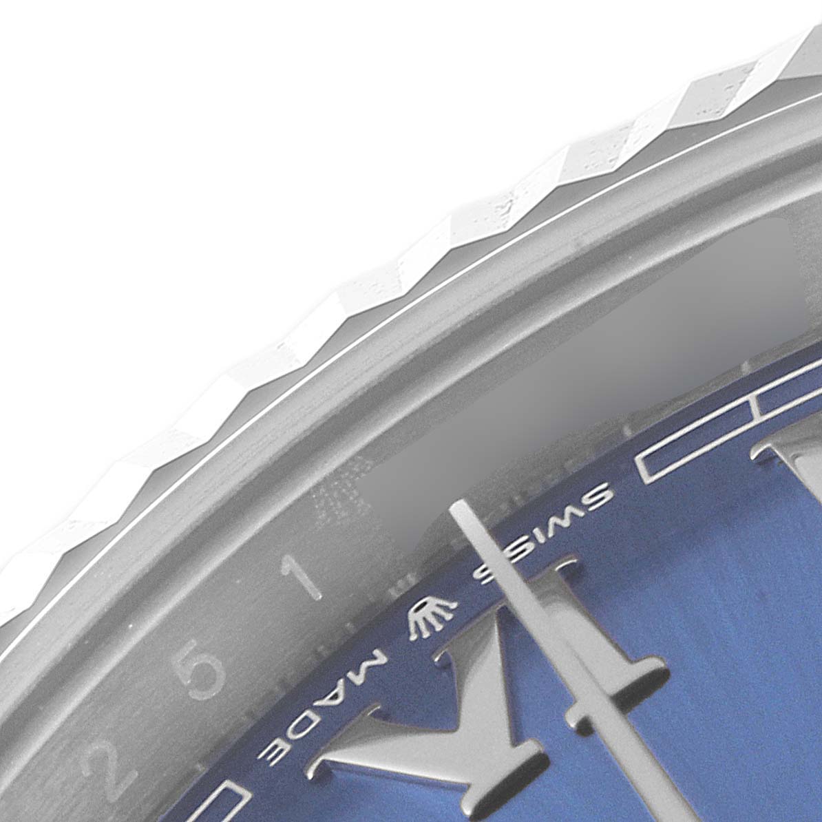 The image shows a close-up of the bezel and part of the dial of a Rolex Datejust 41 126334 Men
s Stainless Steel Blue Dial 126334 Men
s Stainless Steel Blue Dial watch, including the "Swiss Made" text.
