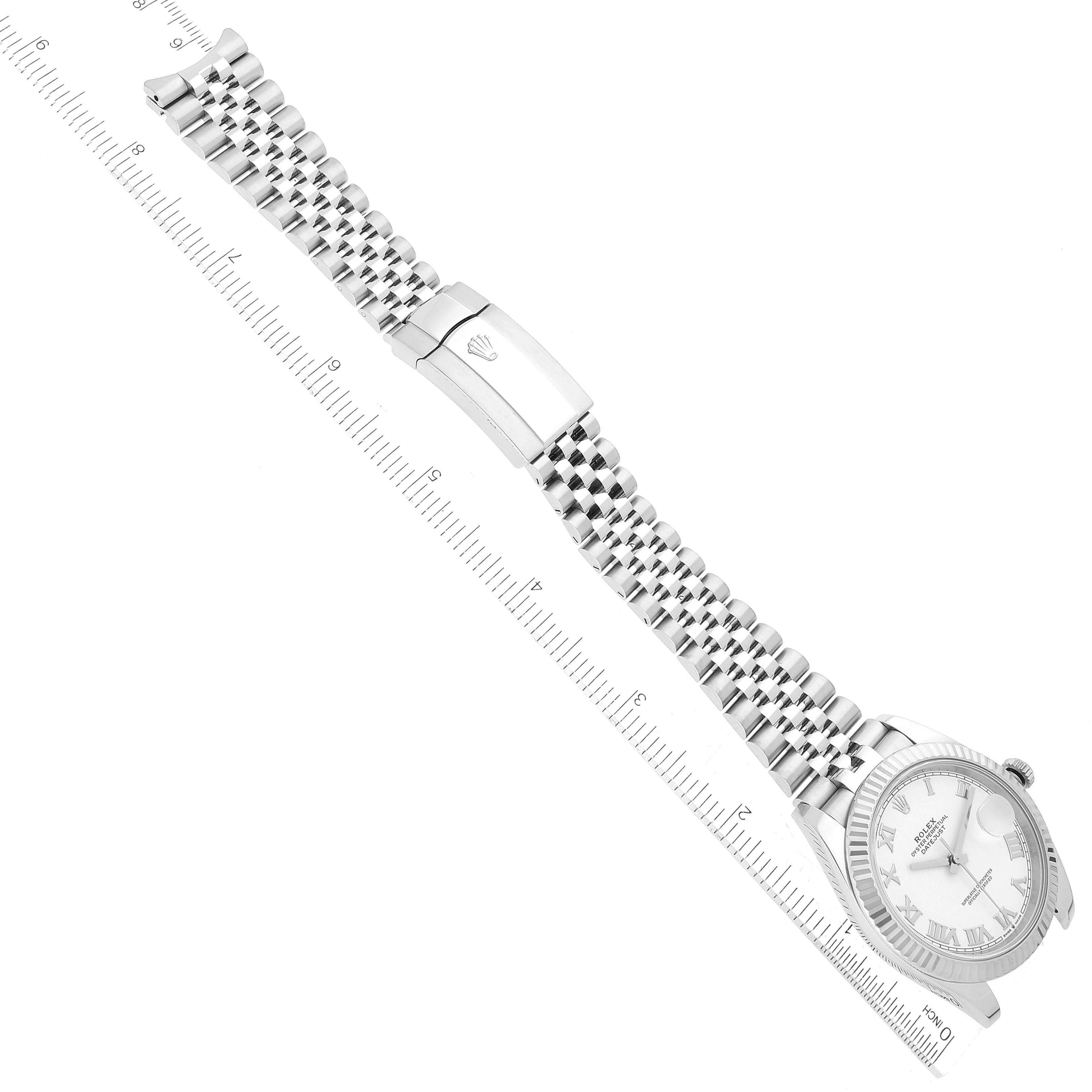 The image shows the Rolex Datejust 41 126334 Men's Stainless Steel White Dial 126334 Men's Stainless Steel White Dial watch from a top view, highlighting its bracelet, clasp, and face alongside a measuring scale.