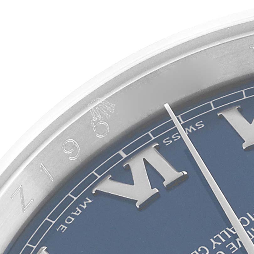 This image shows a close-up of the Rolex Datejust 116200 Men's Stainless Steel Blue Dial 116200 Men's Stainless Steel Blue Dial watch dial, highlighting the Roman numeral VI and part of the case.