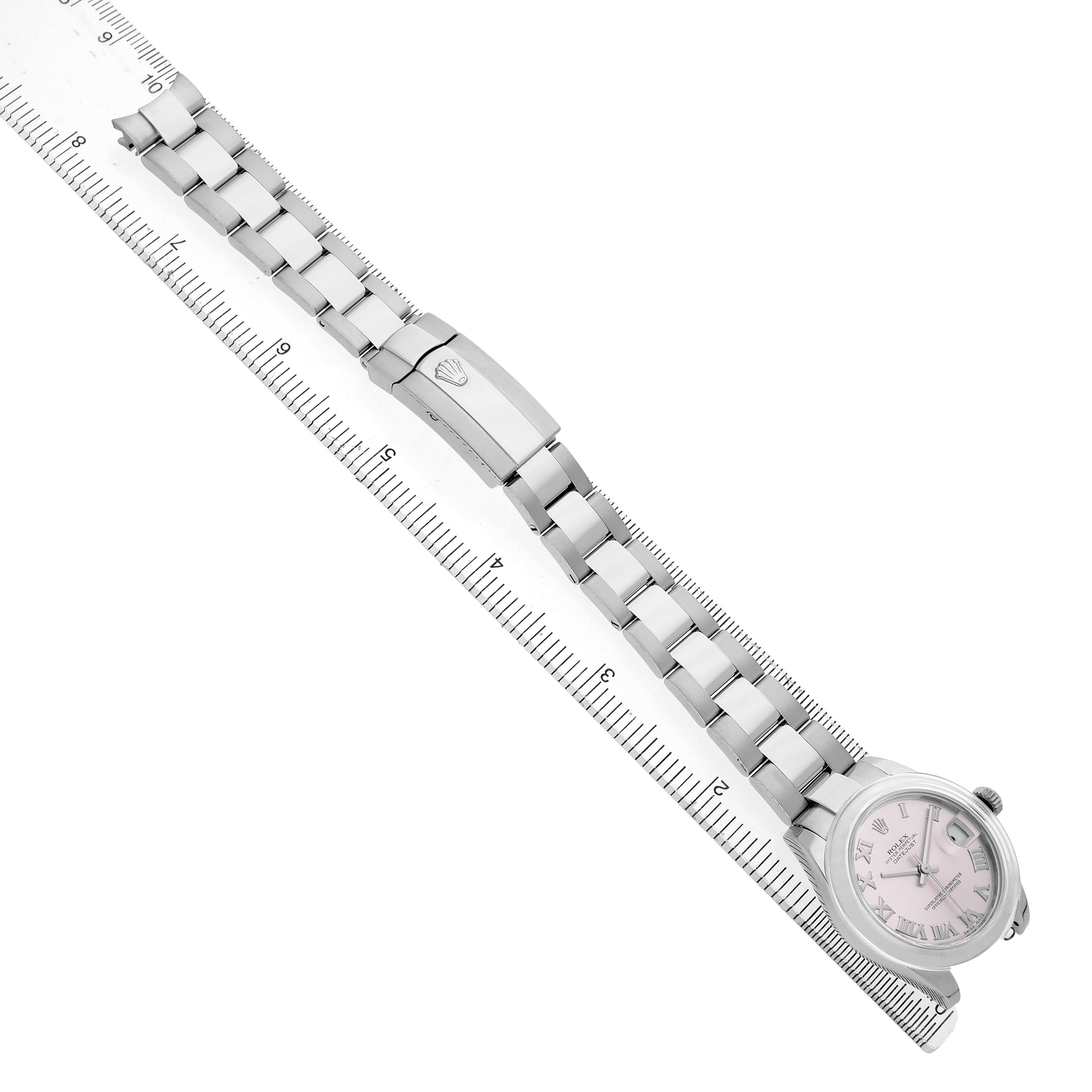 The Rolex Datejust 178240 Women's Stainless Steel Pink Dial watch is shown from a top-down angle, highlighting the strap and clasp, with a ruler for scale.