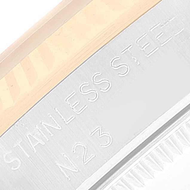 This image shows a close-up angle of the case of a Rolex Mid-Size 68273 Women
s Steel and Gold (two tone) Champagne Dial 68273 Women
s Steel and Gold (two tone) Champagne Dial model watch, with "Stainless Steel" and "N23" engraved on it.