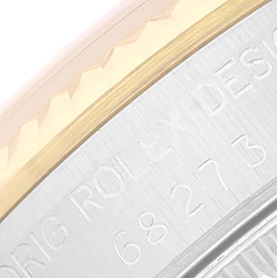The image shows a close-up of the engraved case back and partial bezel of a Rolex Mid-Size 68273 Women
s Steel and Gold (two tone) Champagne Dial 68273 Women
s Steel and Gold (two tone) Champagne Dial model watch.