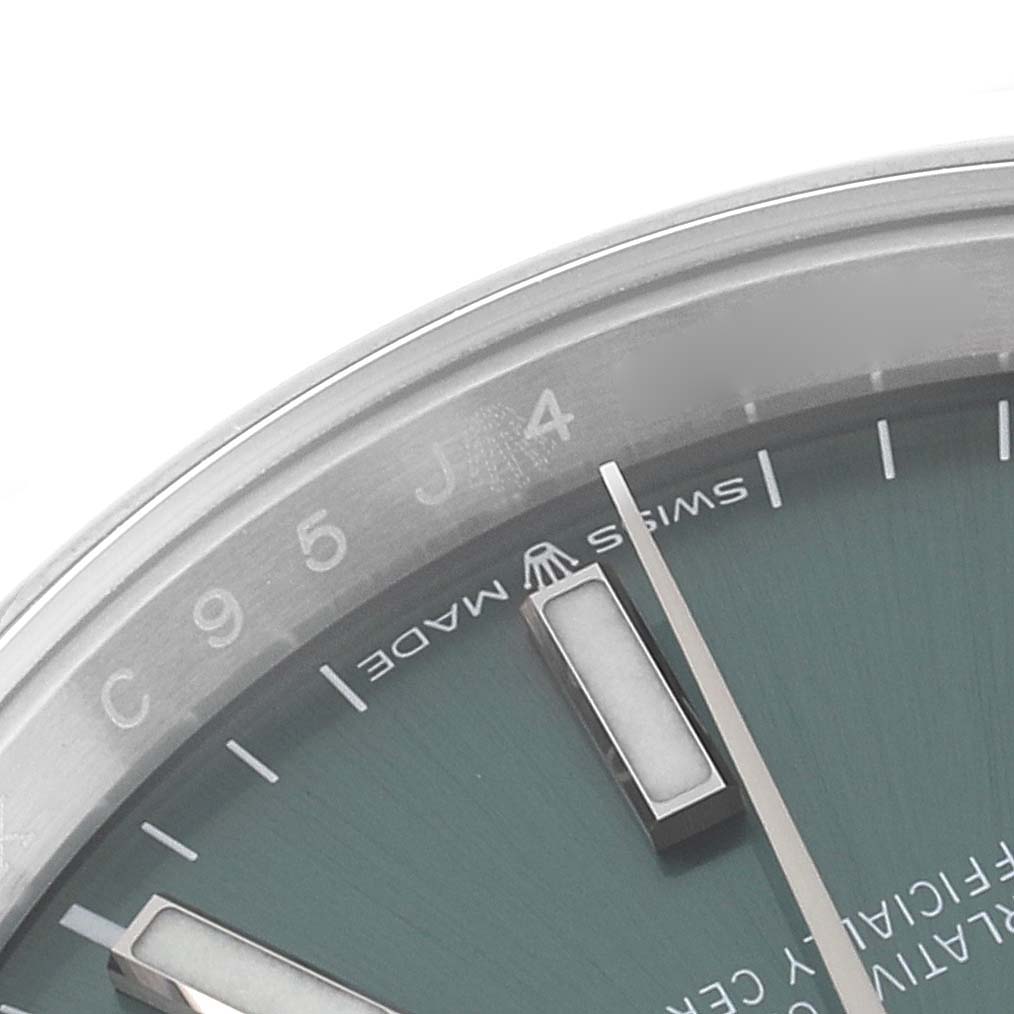 This close-up image shows the dial and bezel of the Rolex Datejust 126200 Men's Stainless Steel Green Dial 126200 Men's Stainless Steel Green Dial watch, highlighting part of the hour markers and "Swiss Made" text.