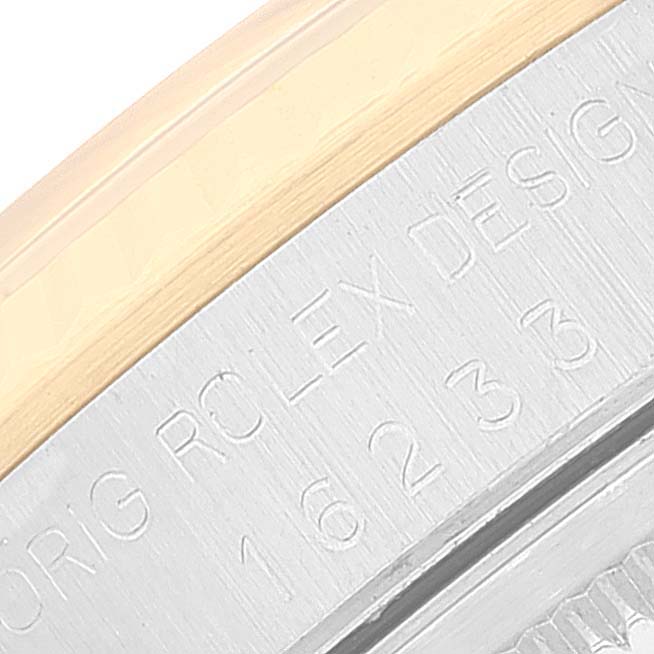 The image shows a close-up angle of the casing of a Rolex Datejust 16233 Men's Steel and Gold (two tone) Champagne Dial 16233 Men's Steel and Gold (two tone) Champagne Dial watch with part of the model number visible.