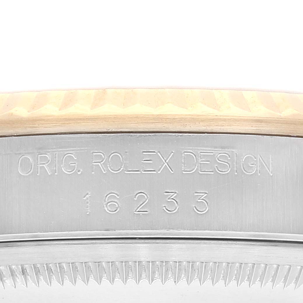 The image shows a close-up of the engraved serial number on the side of a Rolex Datejust 16233 Men's Steel and Gold (two tone) White Dial 16233 Men's Steel and Gold (two tone) White Dial watch.
