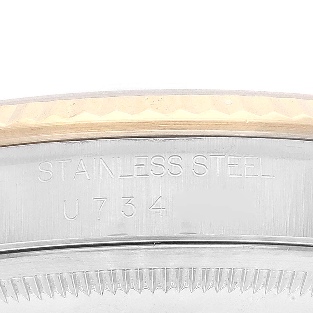The image shows a close-up of the bezel and case back of a Rolex Datejust 16233 Men's Steel and Gold (two tone) White Dial 16233 Men's Steel and Gold (two tone) White Dial watch, with "STAINLESS STEEL" and a serial number engraved.
