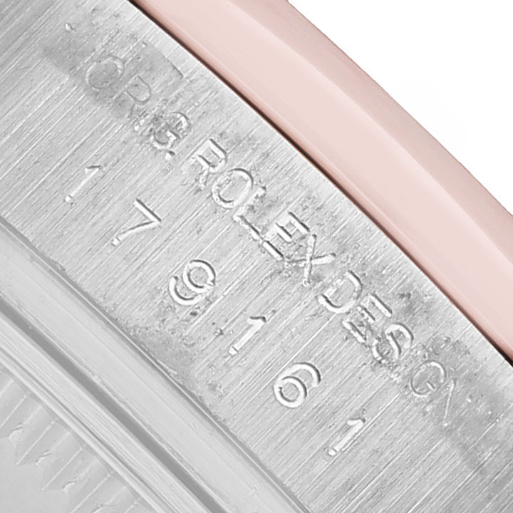 The image shows a close-up of the engraved side of the Rolex Datejust 179161 Women's Steel and Gold (two tone) Pink Dial watch case with the model number and design details visible.