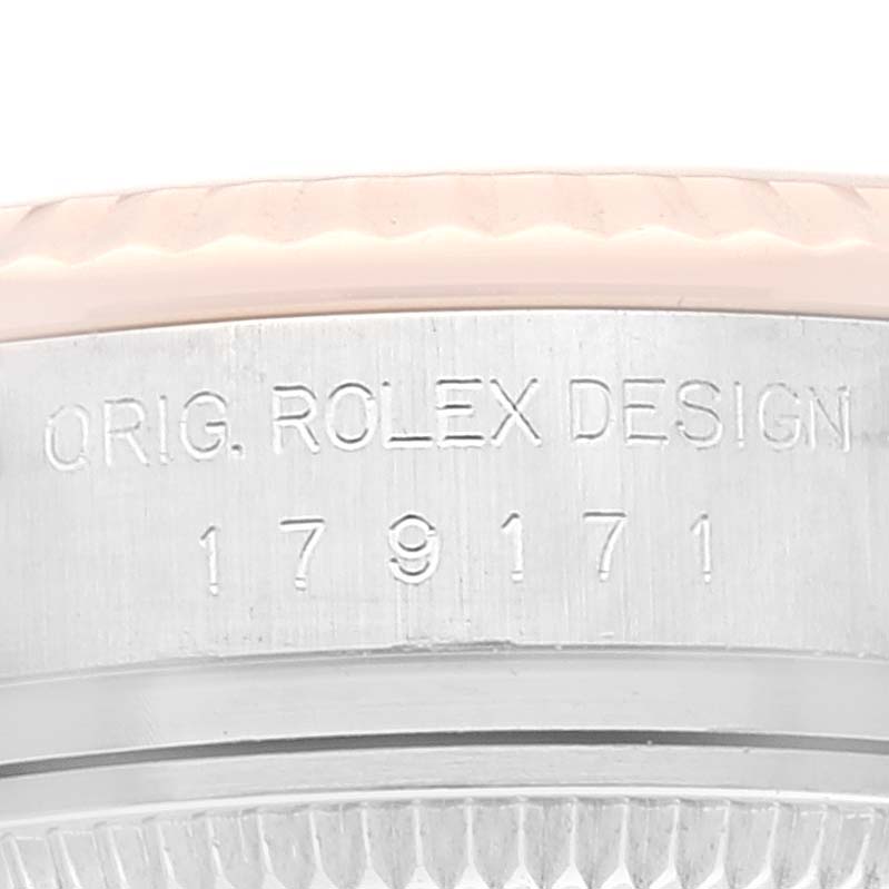 This close-up angle shows the engraved serial number and bit of the bezel on a Rolex Datejust 179171 Women's Steel and Gold (two tone) Silver Dial 179171 Women's Steel and Gold (two tone) Silver Dial model watch.