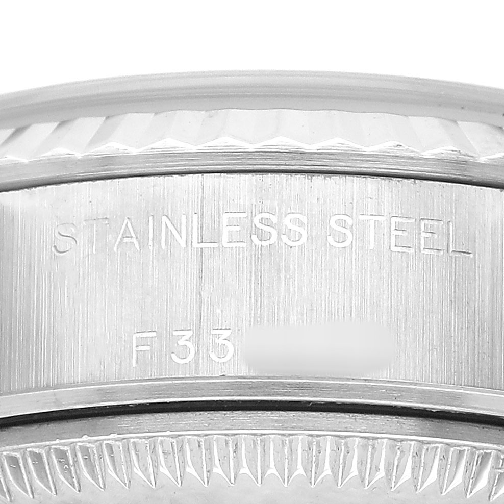 The image shows a close-up of the stainless steel case back and serial engraving on the Rolex Datejust 79174 Women's Stainless Steel Blue Dial.
