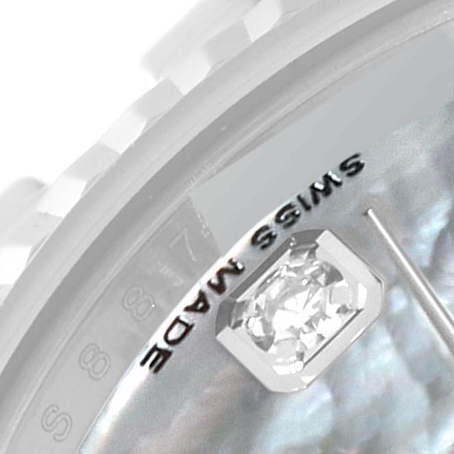 This close-up image shows a portion of the Rolex Datejust 179174 Women's Stainless Steel Mother of Pearl Dial 179174 Women's Stainless Steel Mother of Pearl Dial's dial, highlighting a diamond marker and text.