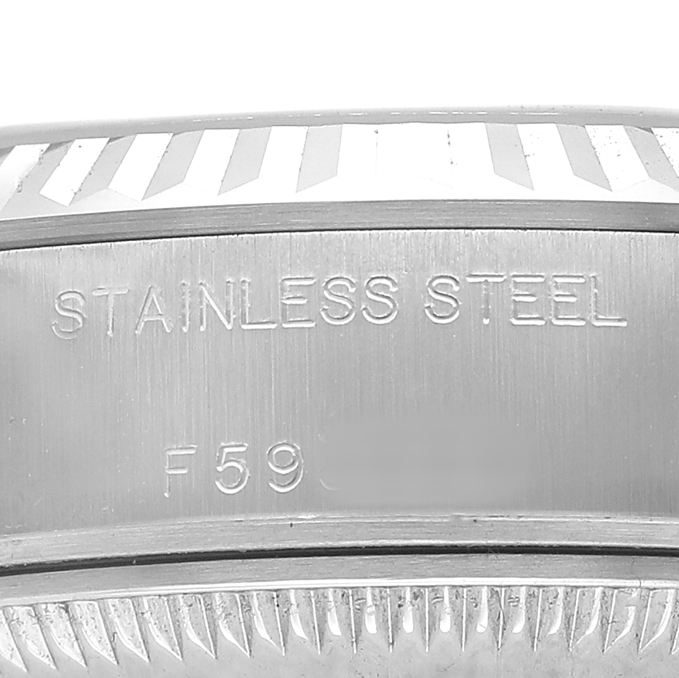 The image shows a close-up of the side of a Rolex Datejust 179174 Women's Stainless Steel White Dial watch case, highlighting the bezel and the "STAINLESS STEEL" engraving.