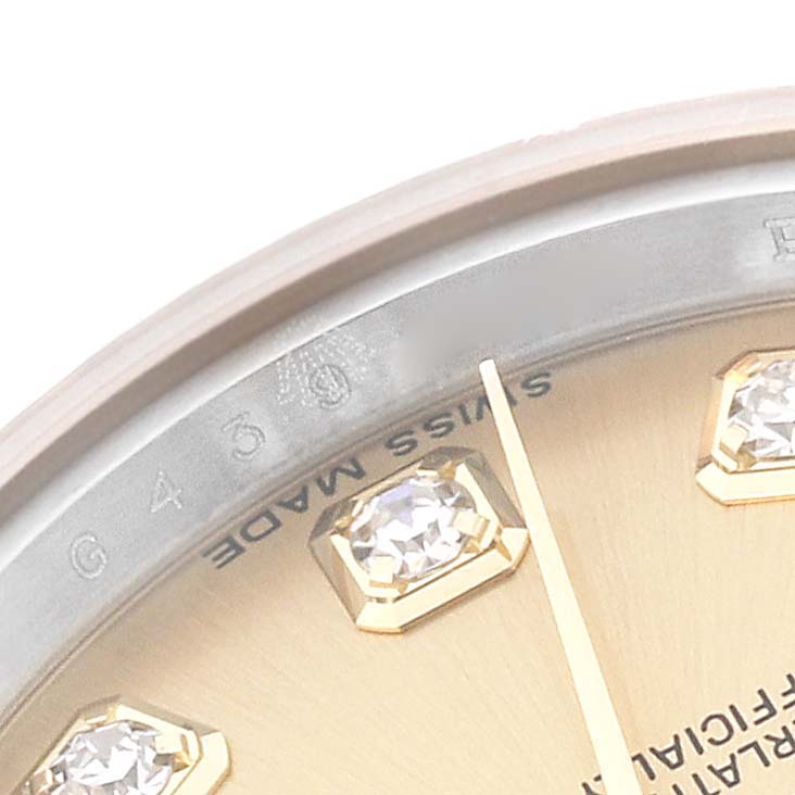 This close-up image of the Rolex Datejust 179173 Women's Steel and Gold (two tone) Champagne Dial 179173 Women's Steel and Gold (two tone) Champagne Dial shows part of the dial with diamond hour markers and the "Swiss Made" inscription.