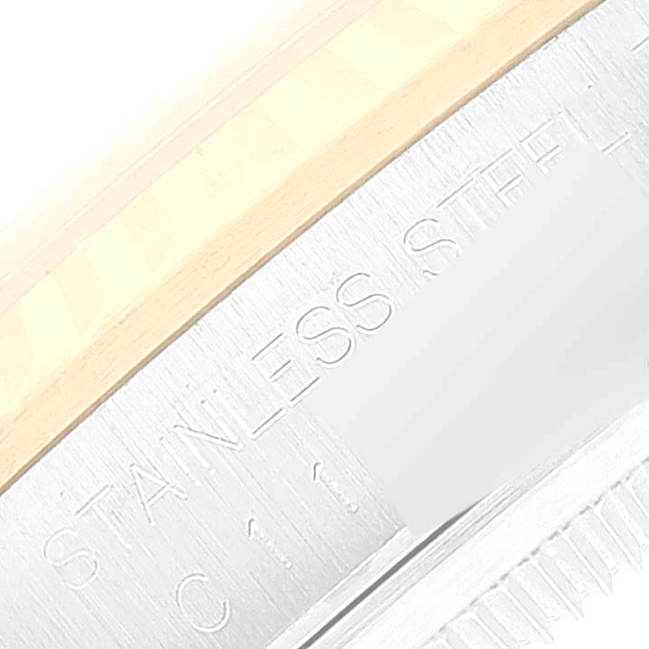 The image shows a close-up of the edge of a Rolex Datejust 16233 Men's Steel and Gold (two tone) White Dial 16233 Men's Steel and Gold (two tone) White Dial watch, highlighting "Stainless Steel" engraving.