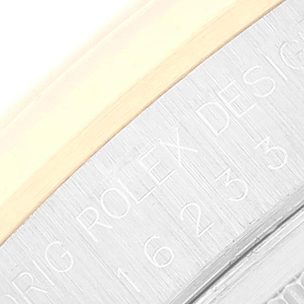 This close-up image shows the engraved outer edge of the Rolex Datejust 16233 Men's Steel and Gold (two tone) White Dial 16233 Men's Steel and Gold (two tone) White Dial's case back, highlighting the brand and model details.
